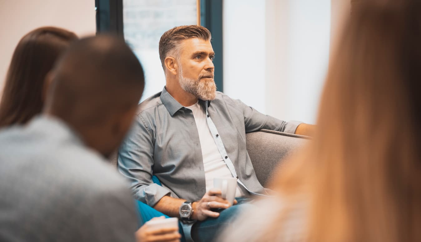 Group of business people talking about new strategies in break room. Group of business people in office cafeteria, on coffee break, chatting, drinking coffee