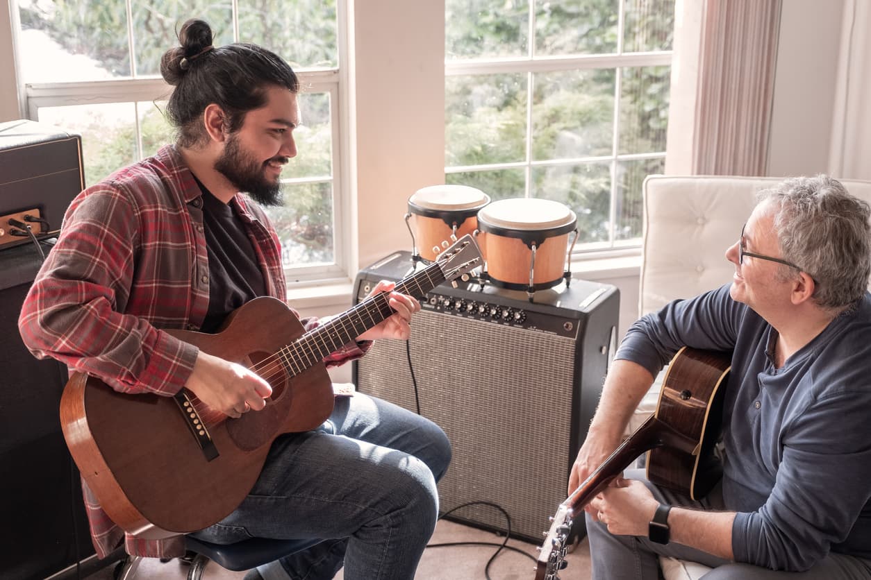 two men playing guitar music