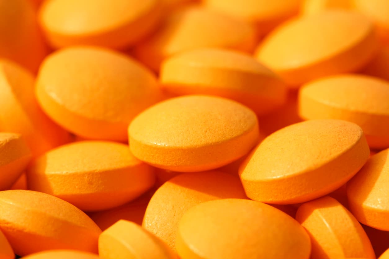 multiple orange pills close up