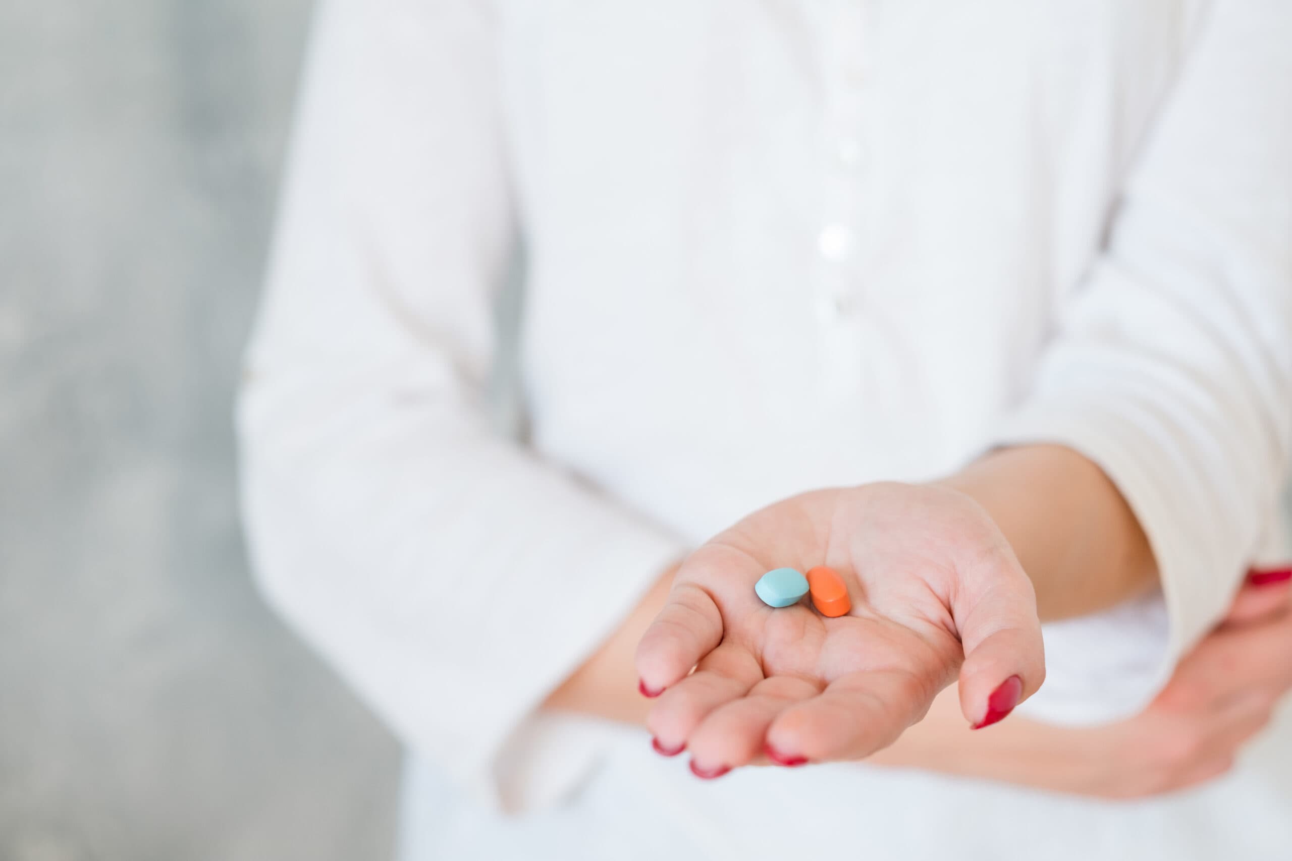 woman hand two pills pain medication health