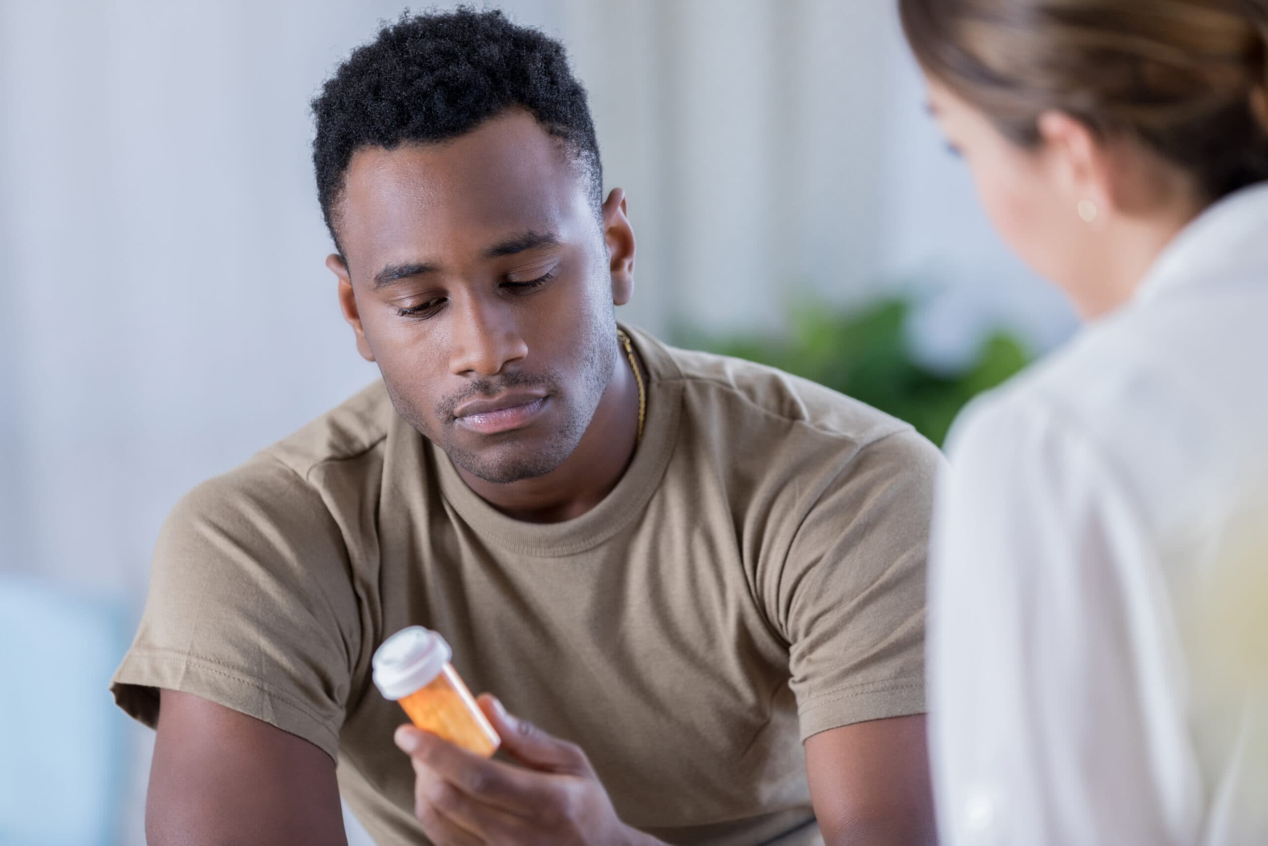 man with empty pill bottle