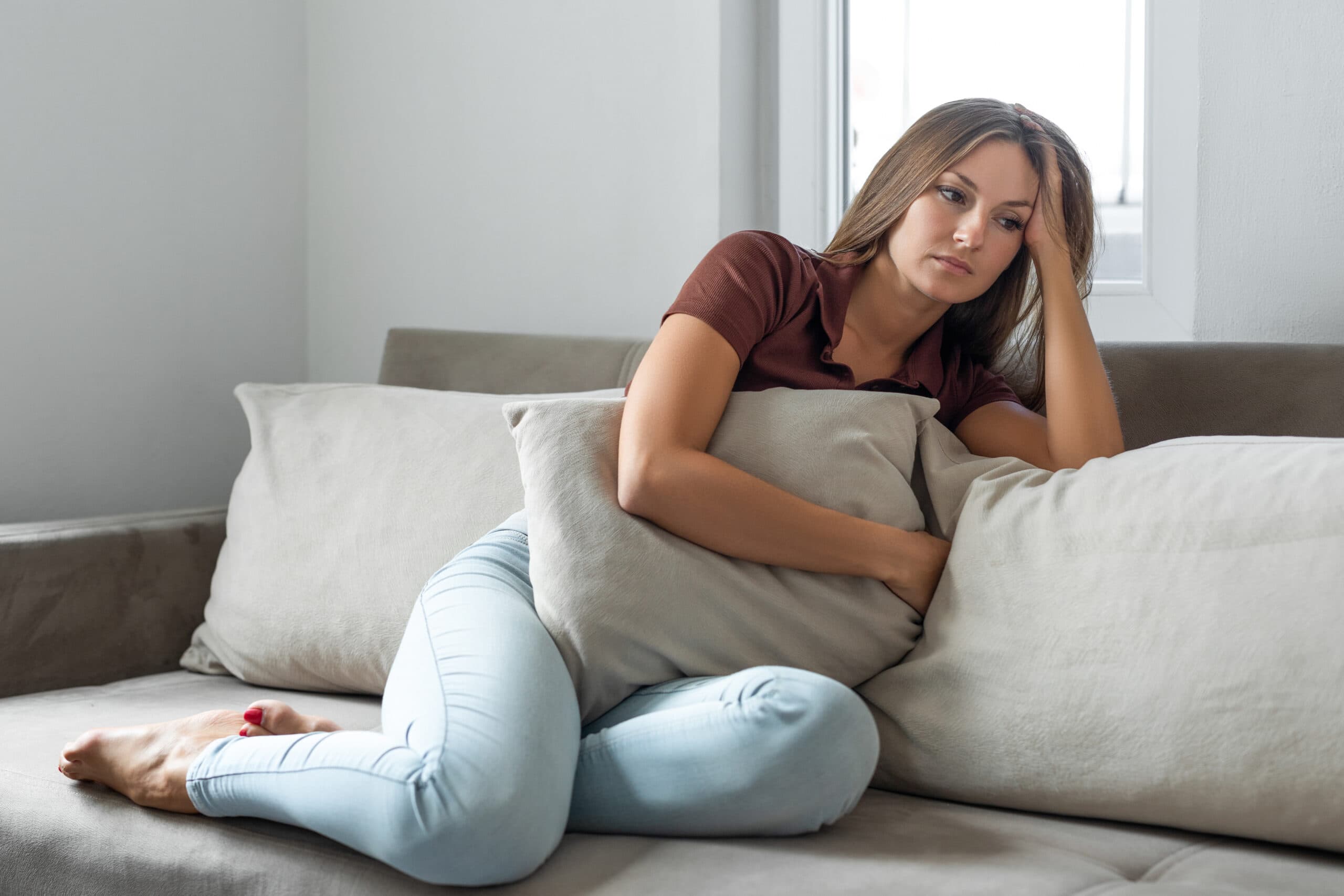 sad woman sitting on couch