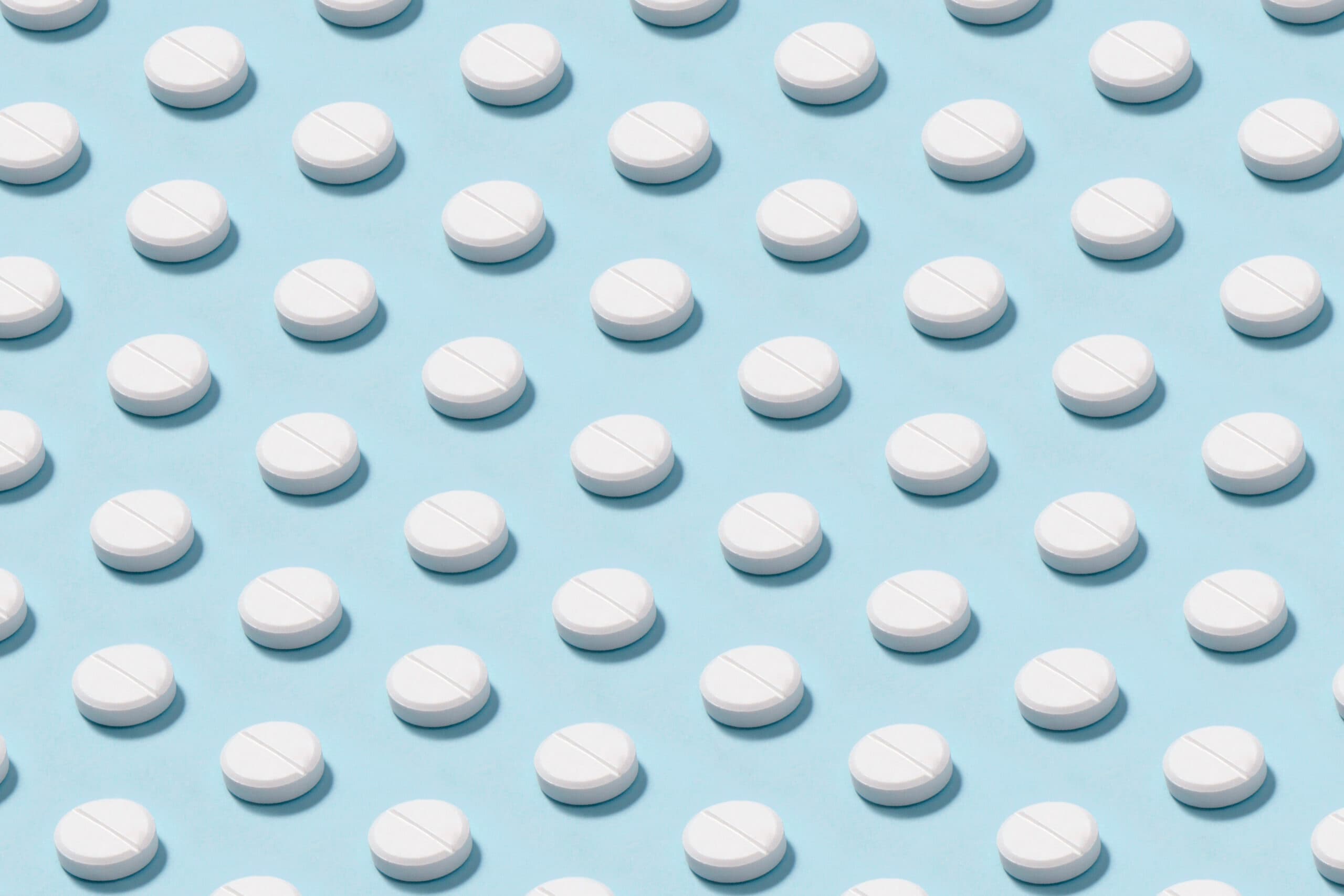 white pills on blue background