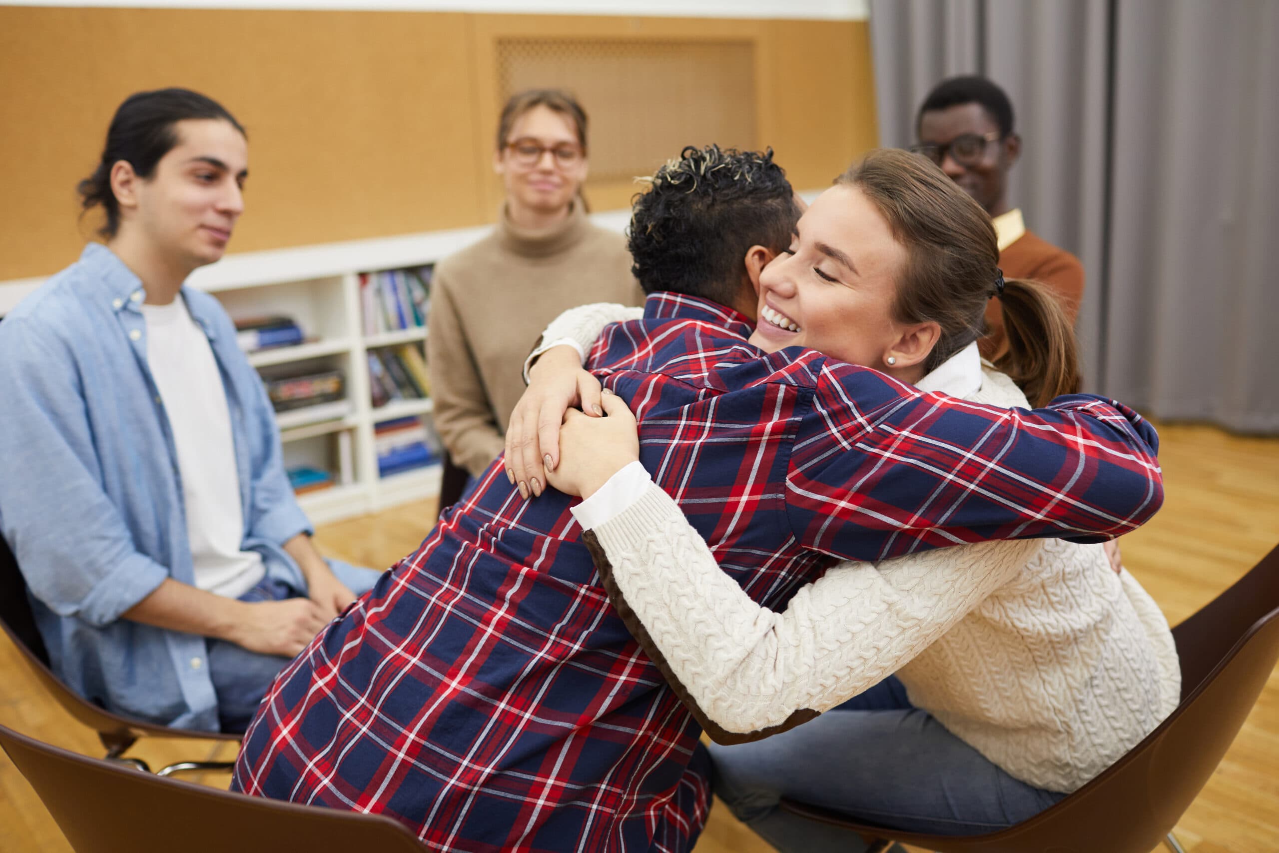 two people hugging in circle at rehab