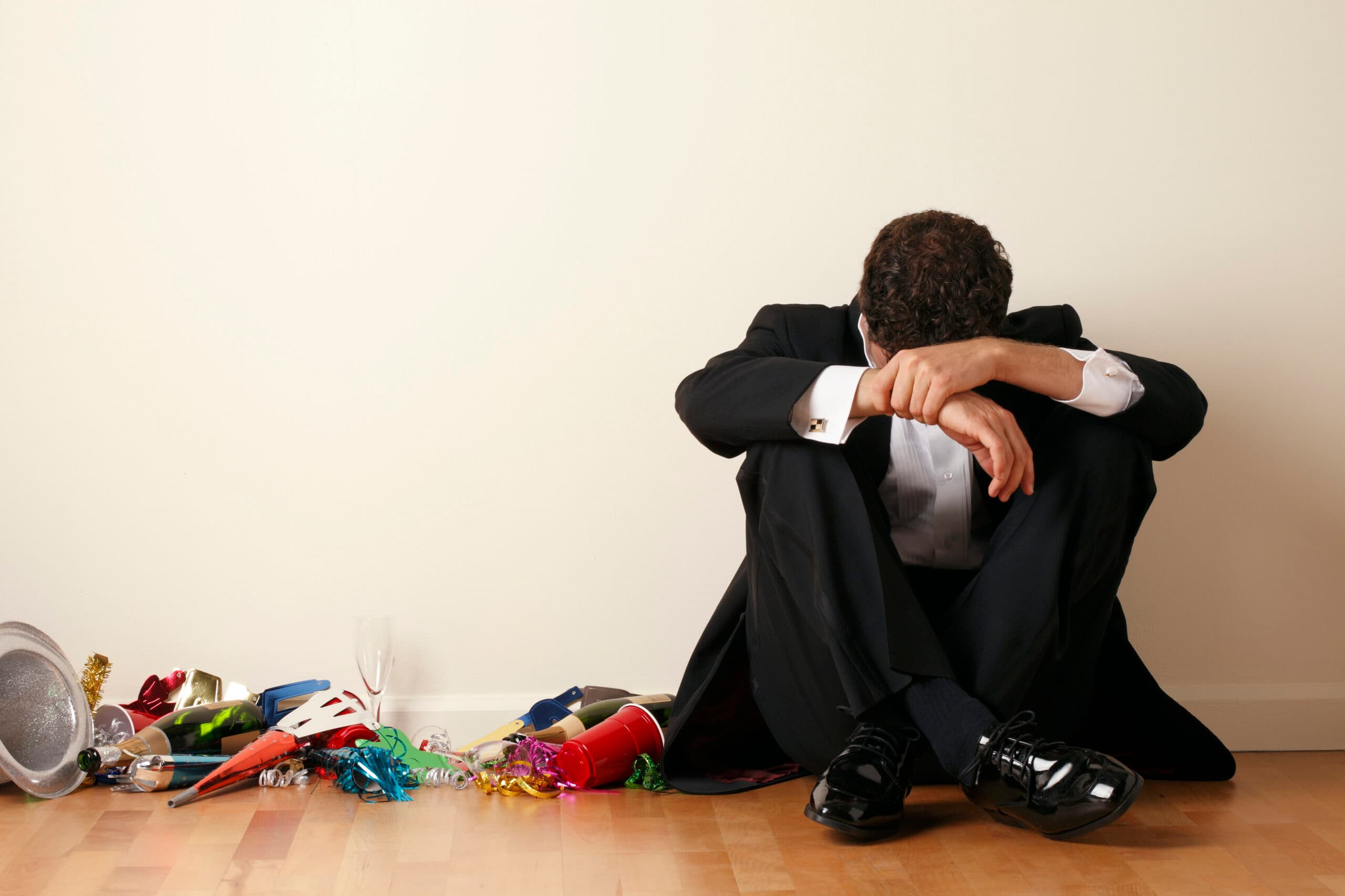 man in tuxedo hungover new years party