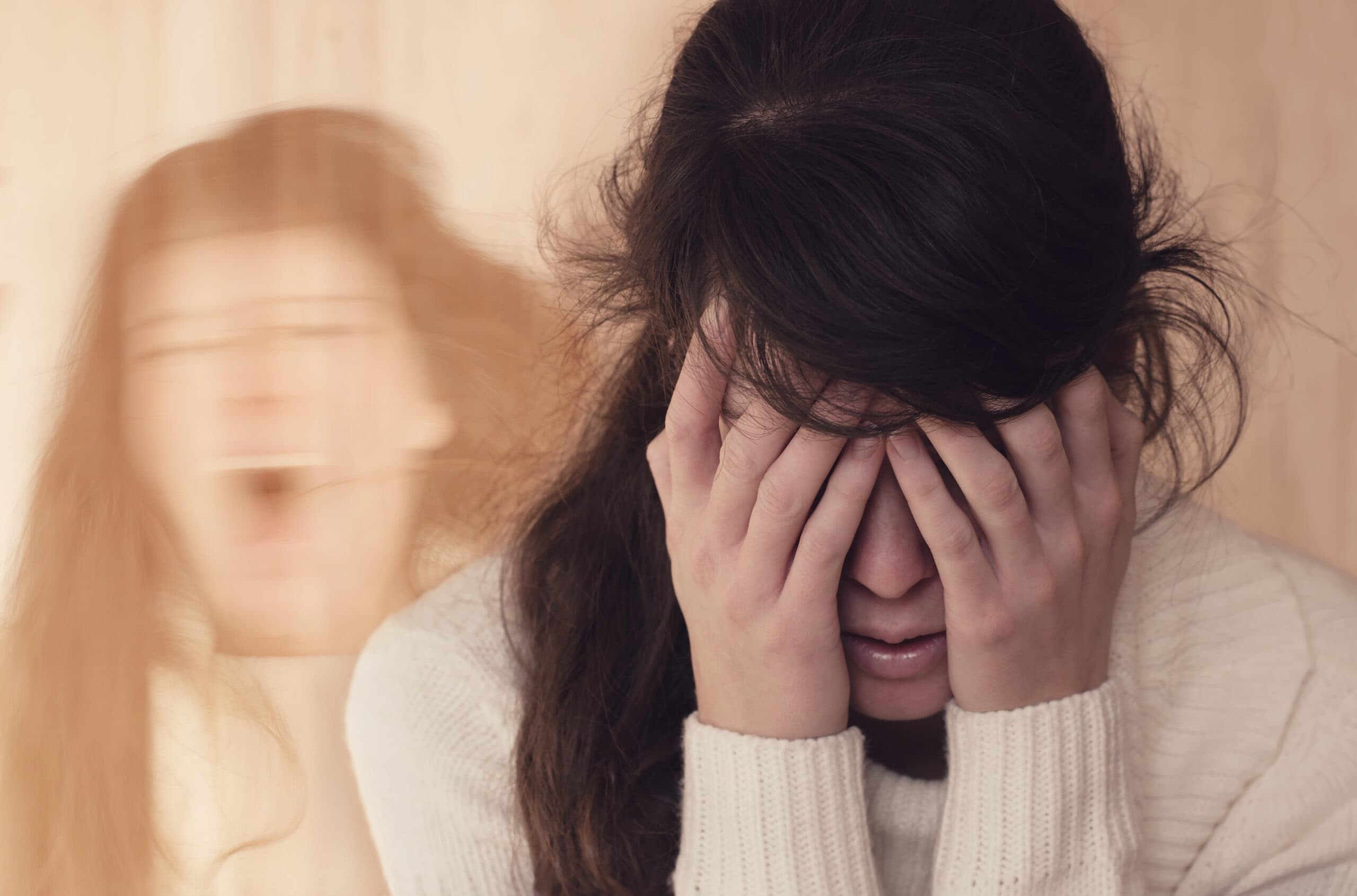 woman suffering withdrawal head in hands and screaming