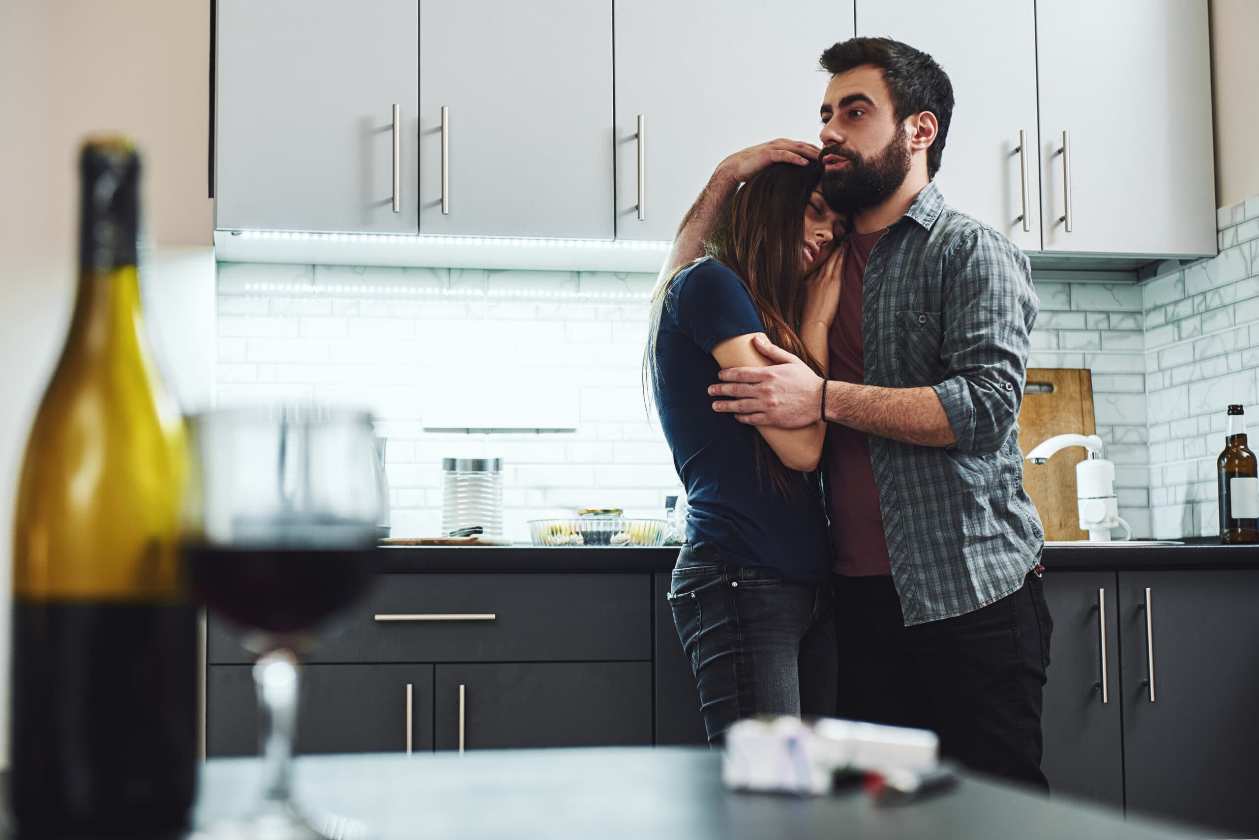 man holding drunk wife alcoholic