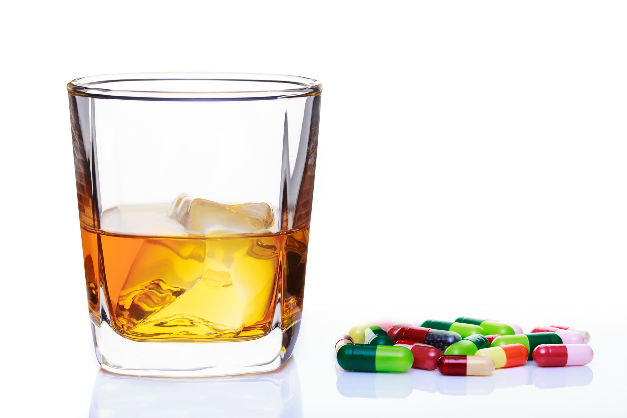 whiskey glass with pills