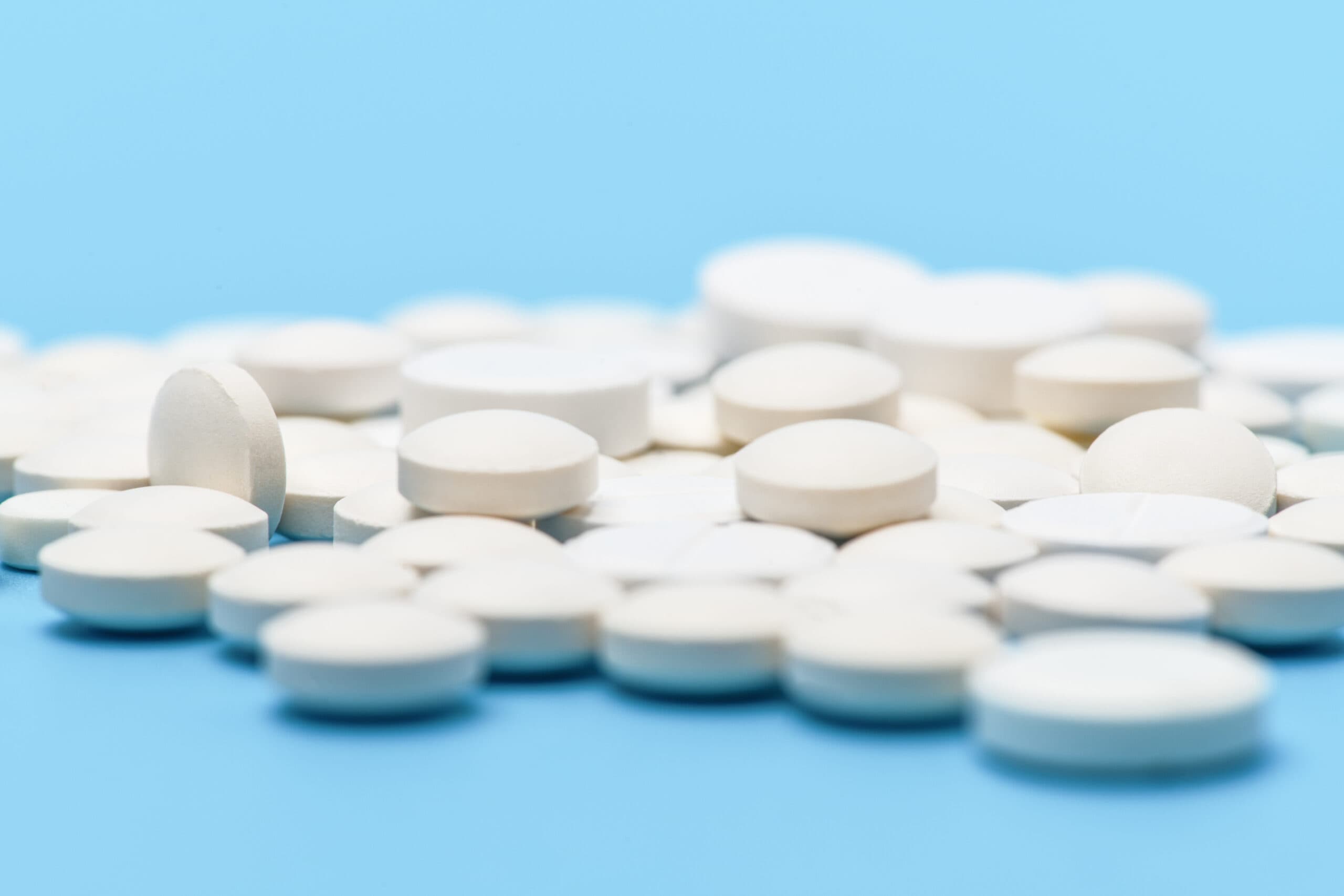 round white pills lorazepam on blue background