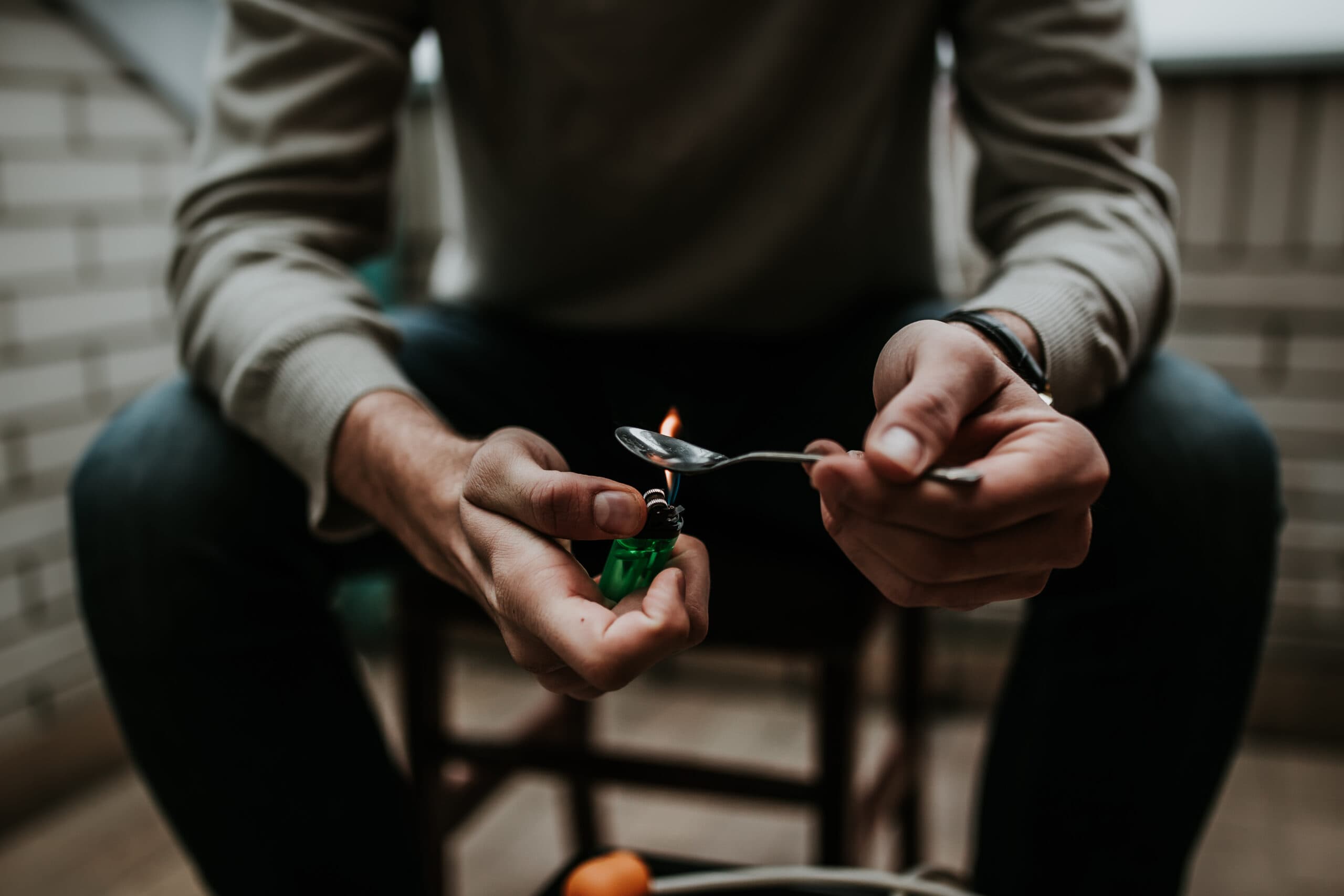 morphine addict preparing drugs on spoon