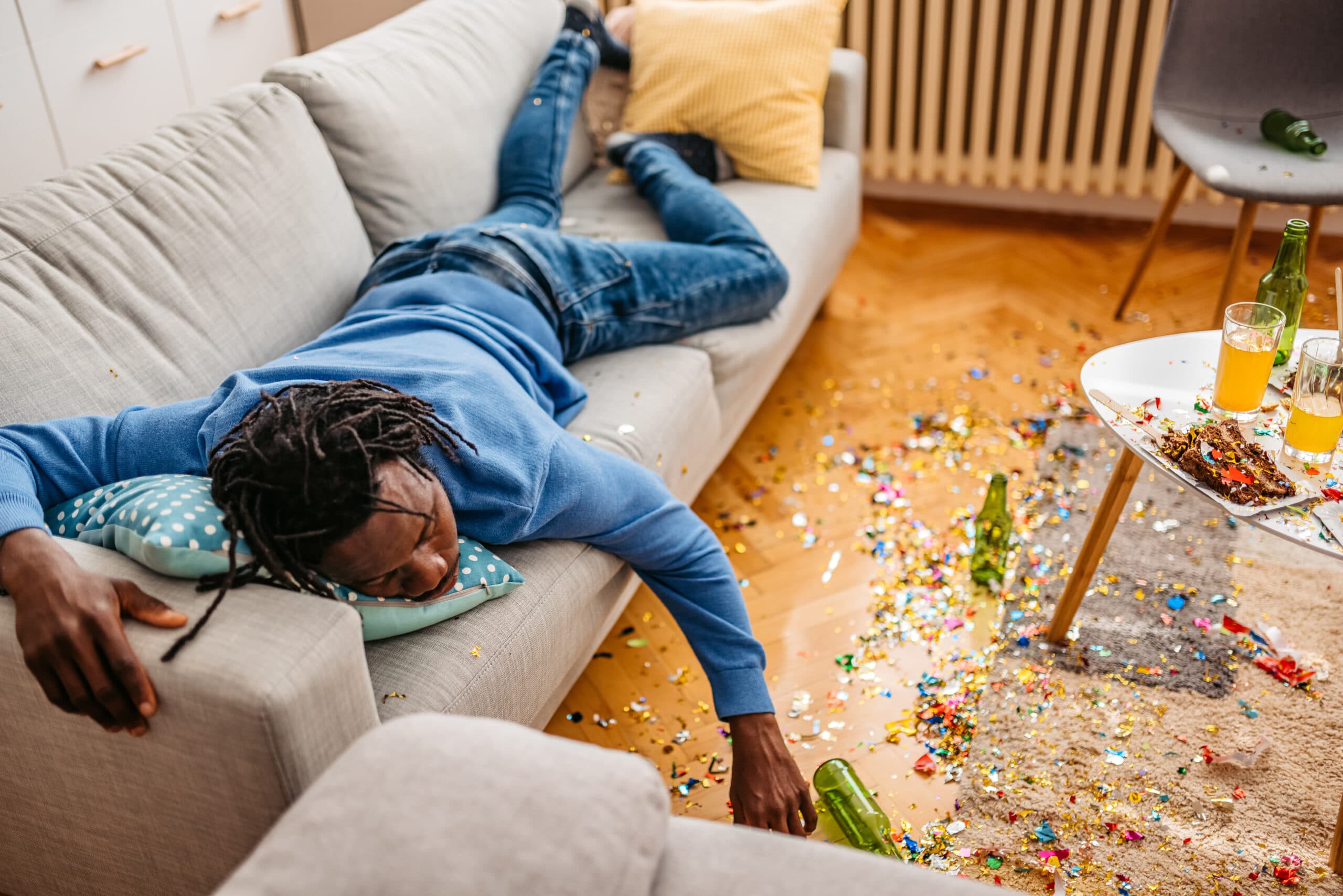 young man asleep on couch beer passed out