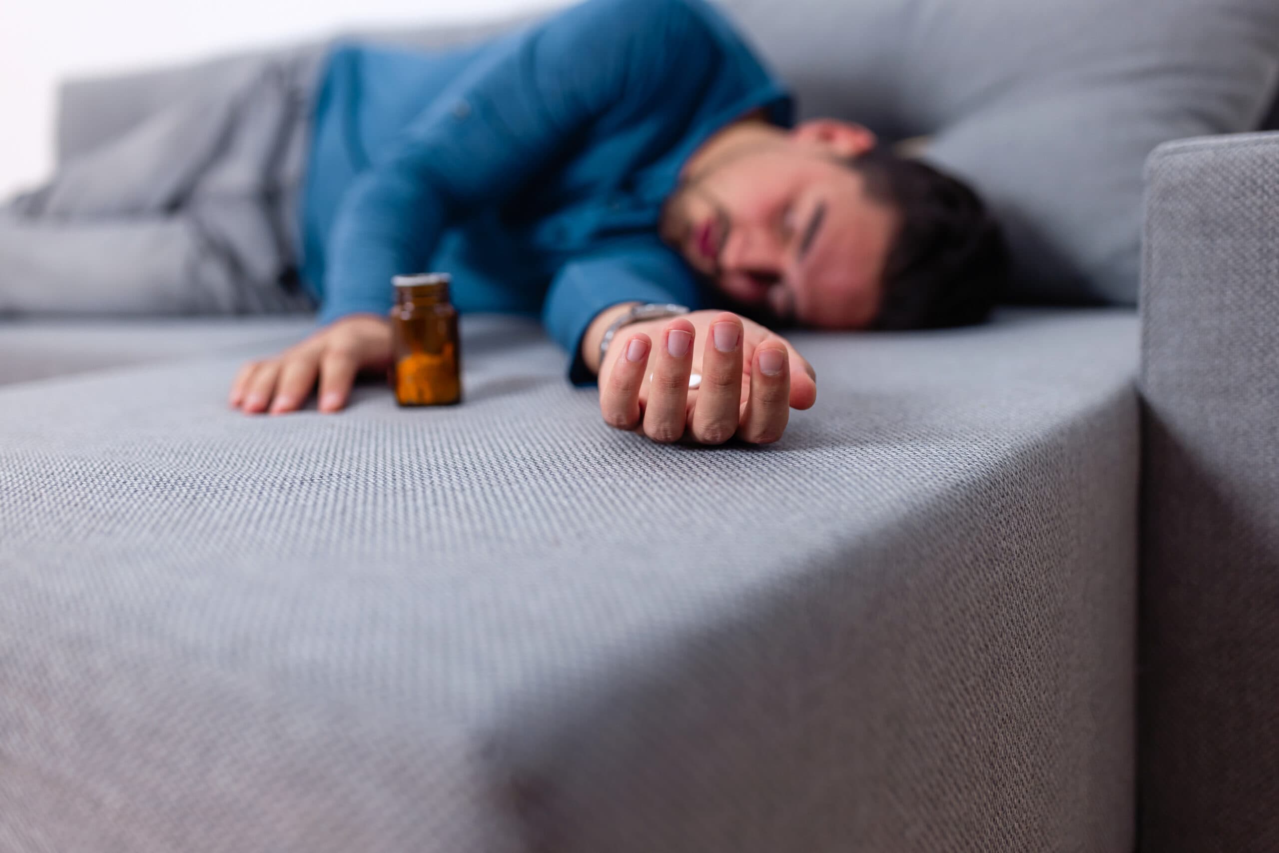 man asleep on couch fentanyl addict