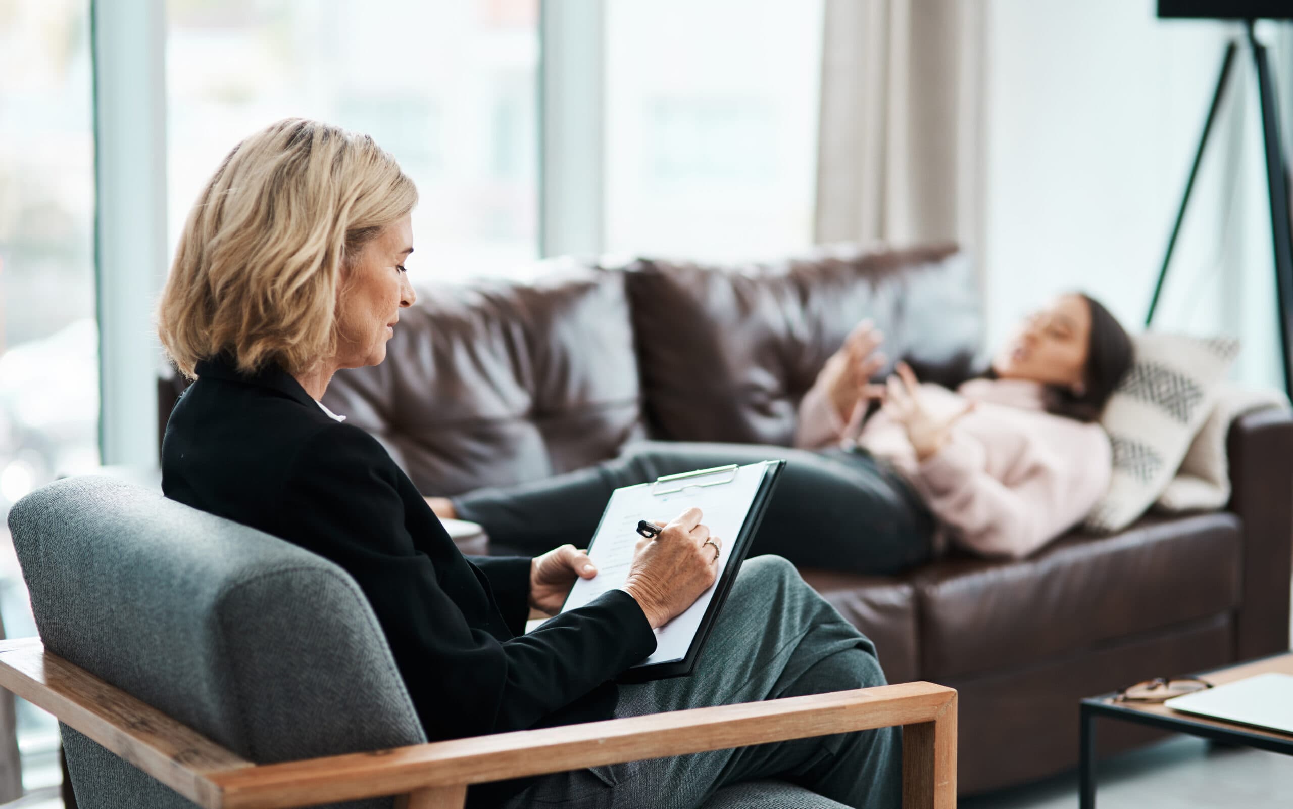 therapist and patient talking laying down