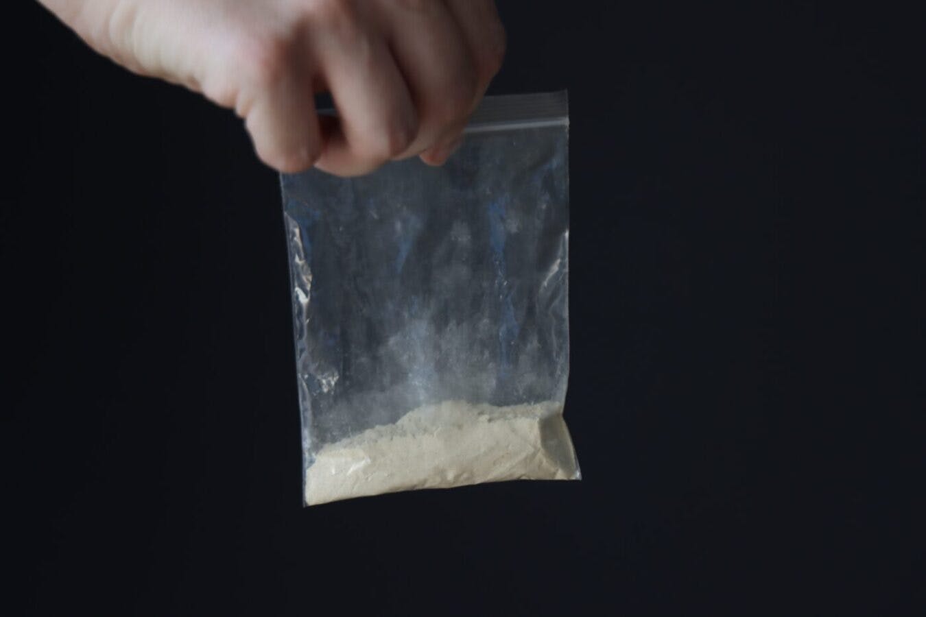 woman holding heroin bag drugs