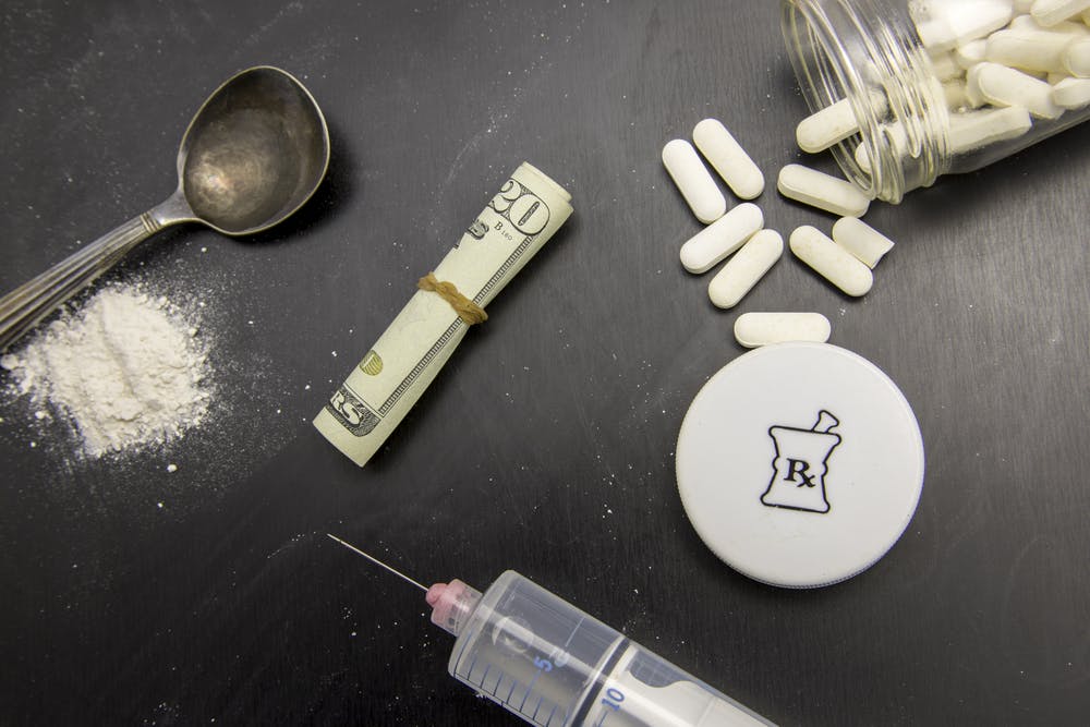 heroin fentanyl pills money spoon needle