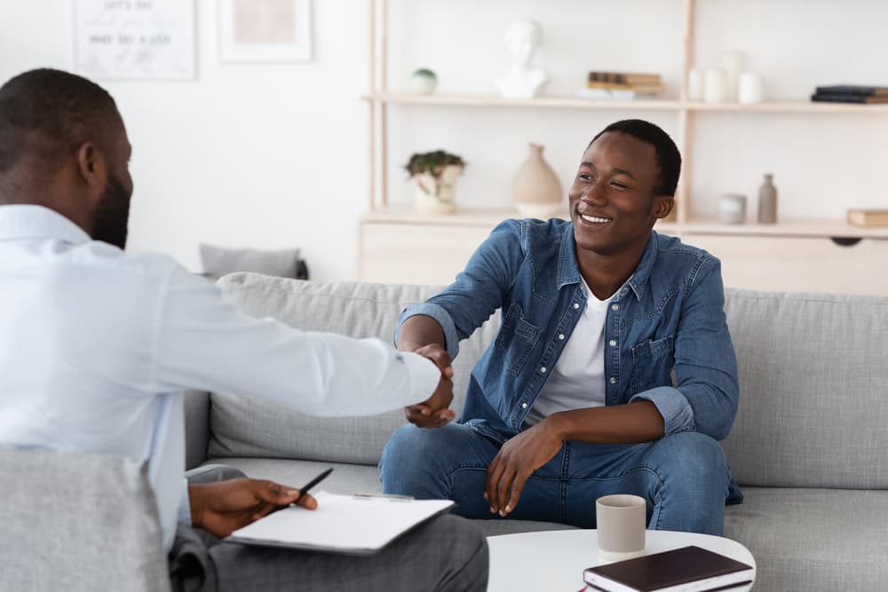 addiction counselor and client shaking hands