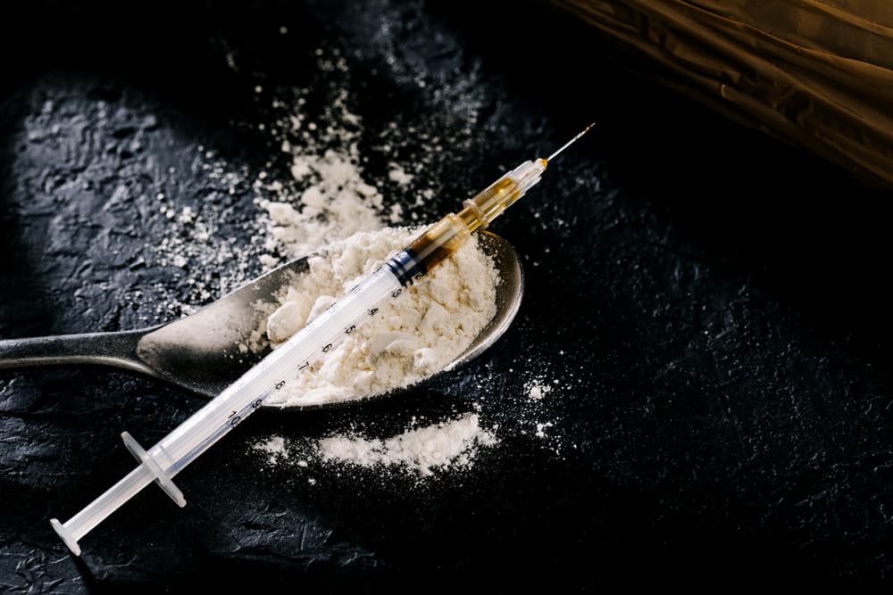 heroin in syringe and spoon