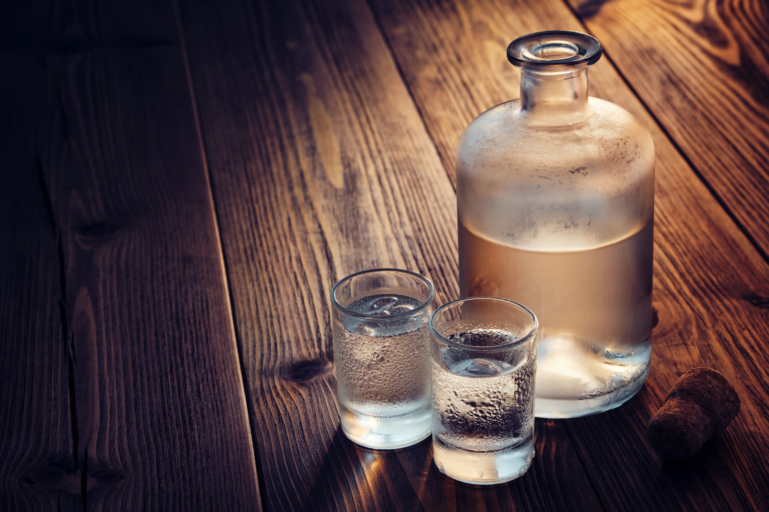 moonshine liquor in shot glasses and bottle