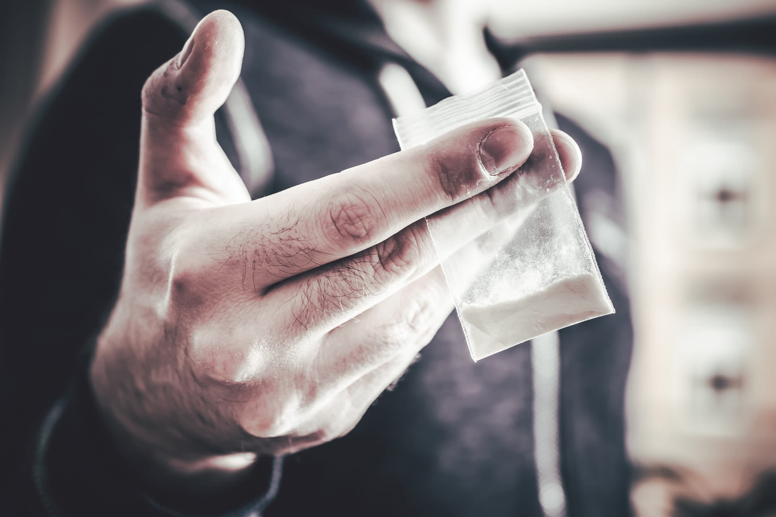 man holding cocaine baggie