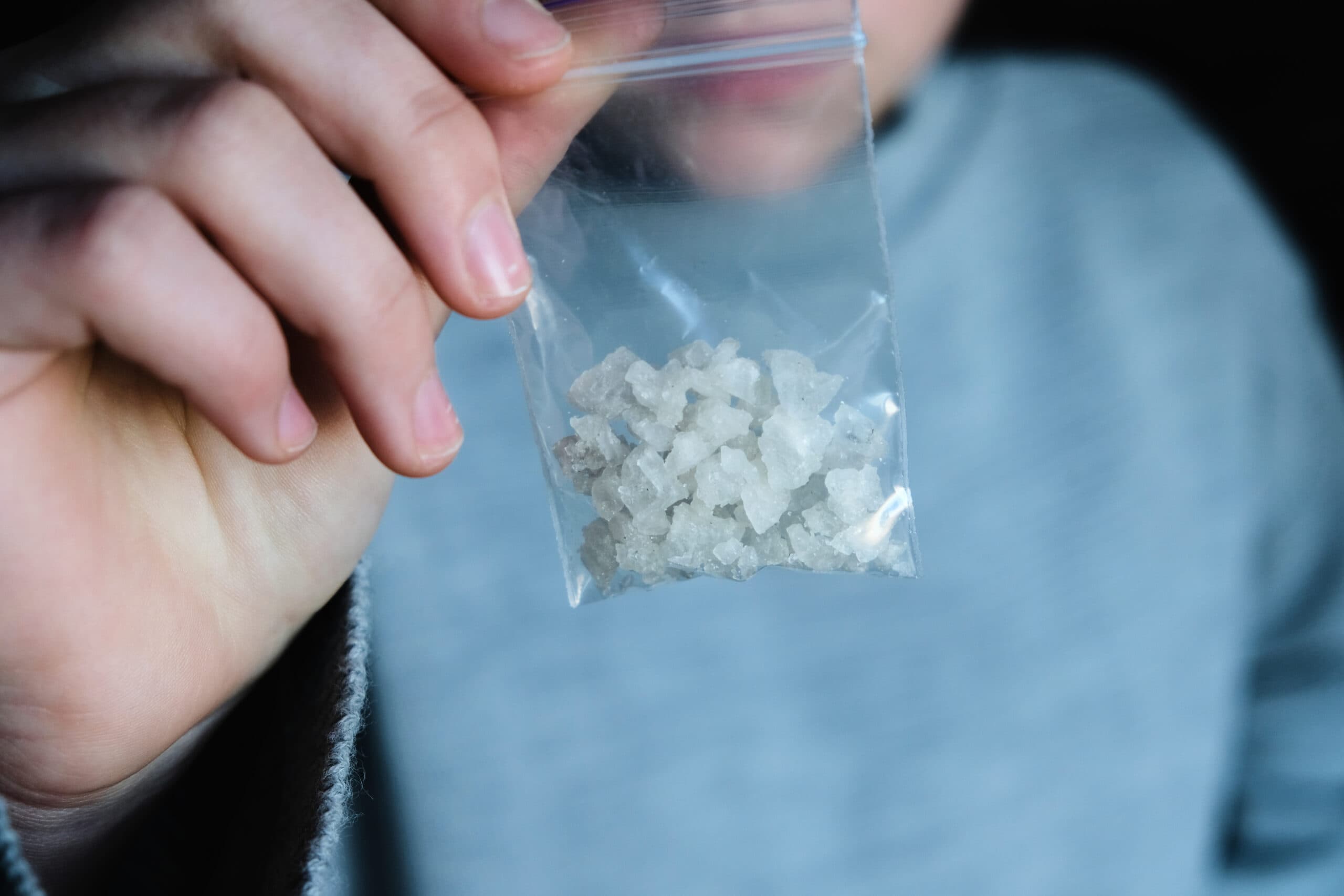 man holding bag of meth