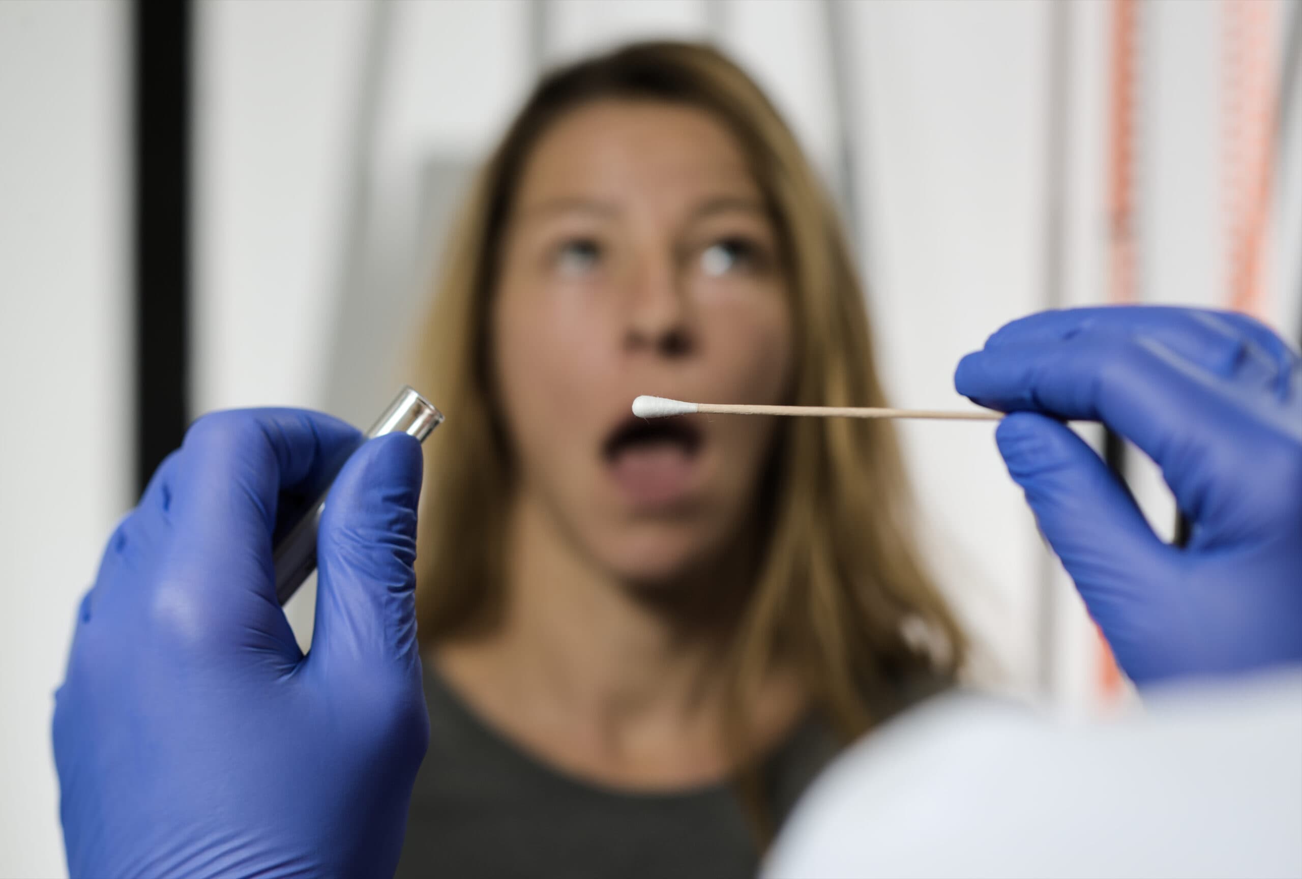 woman getting mouth swab drug test