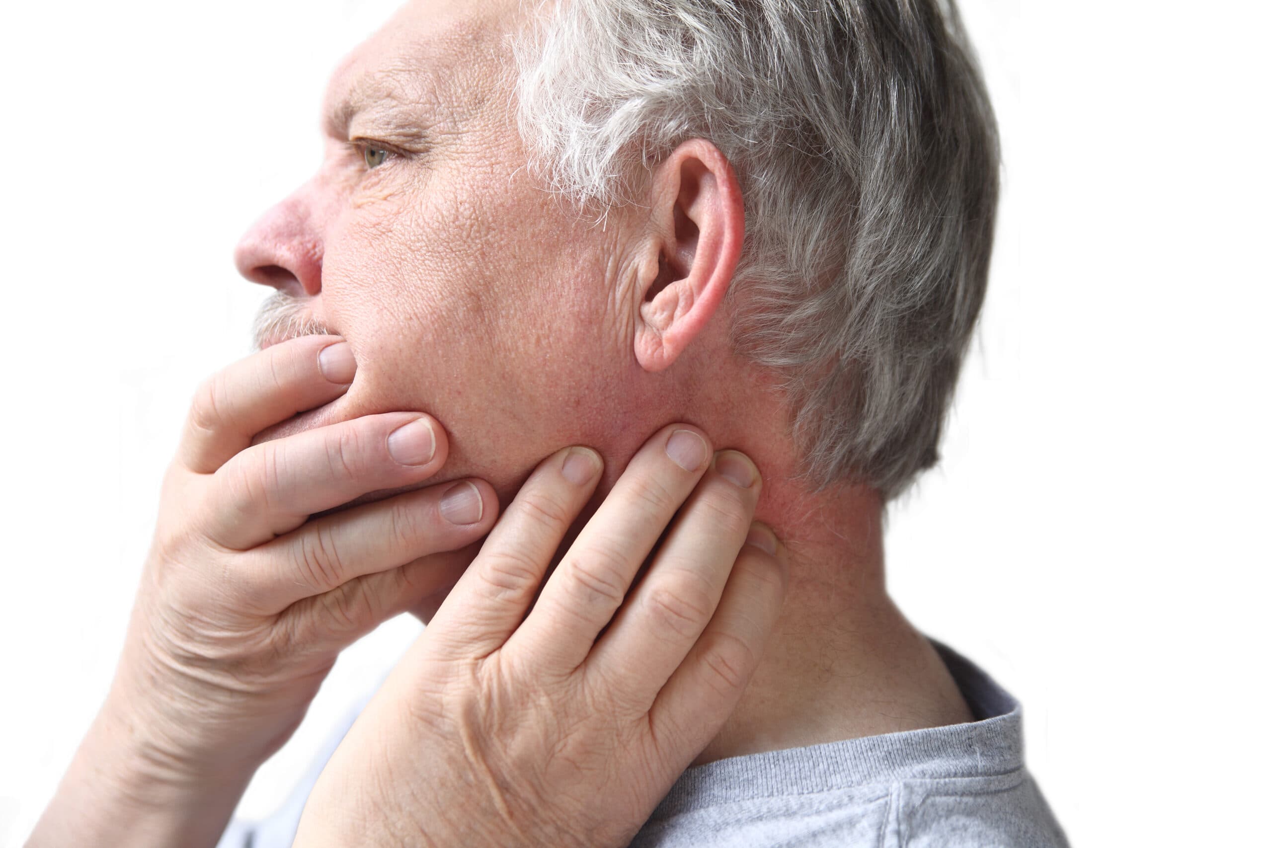 older man with holding jaw