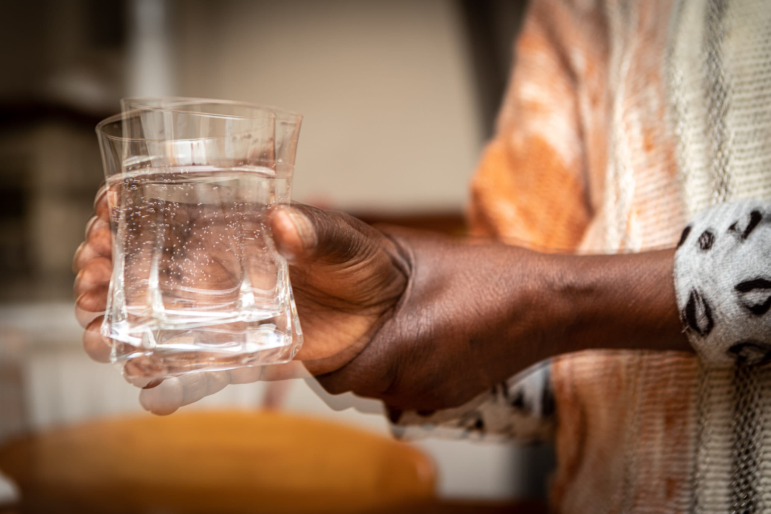 woman holding glass with shaky hands