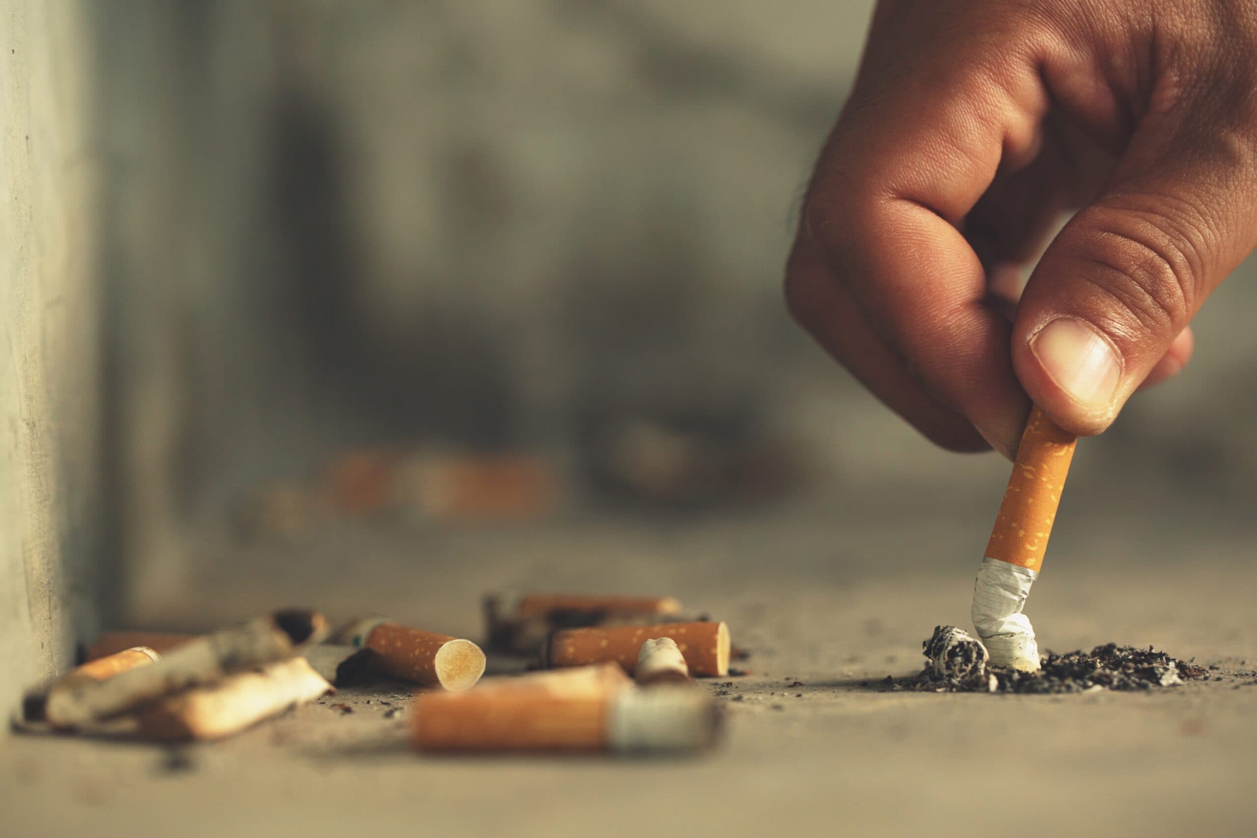 man putting out cigarette