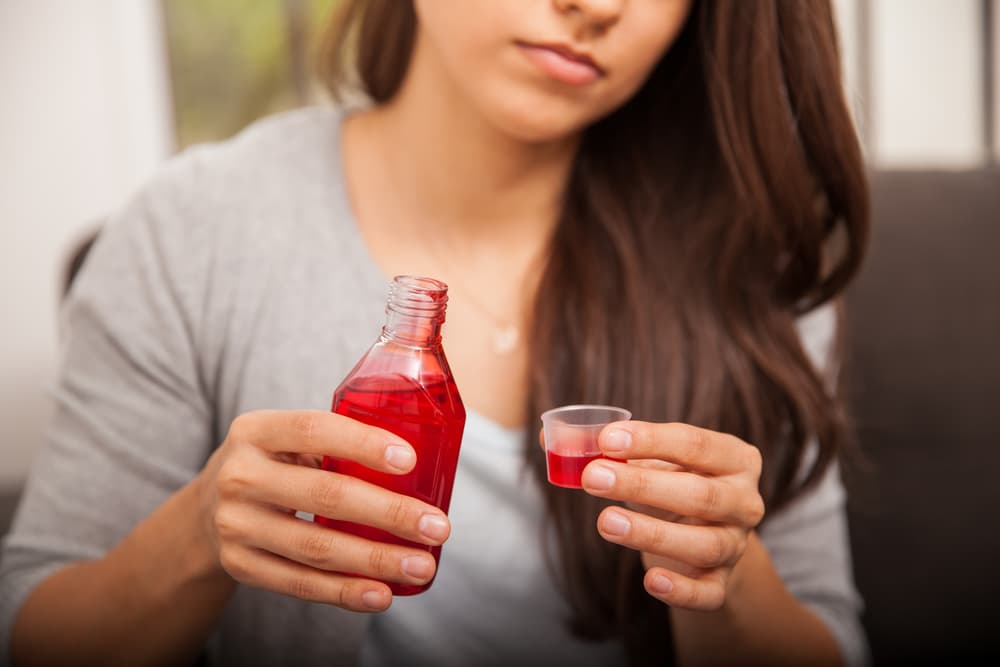 woman with bottle of dxm