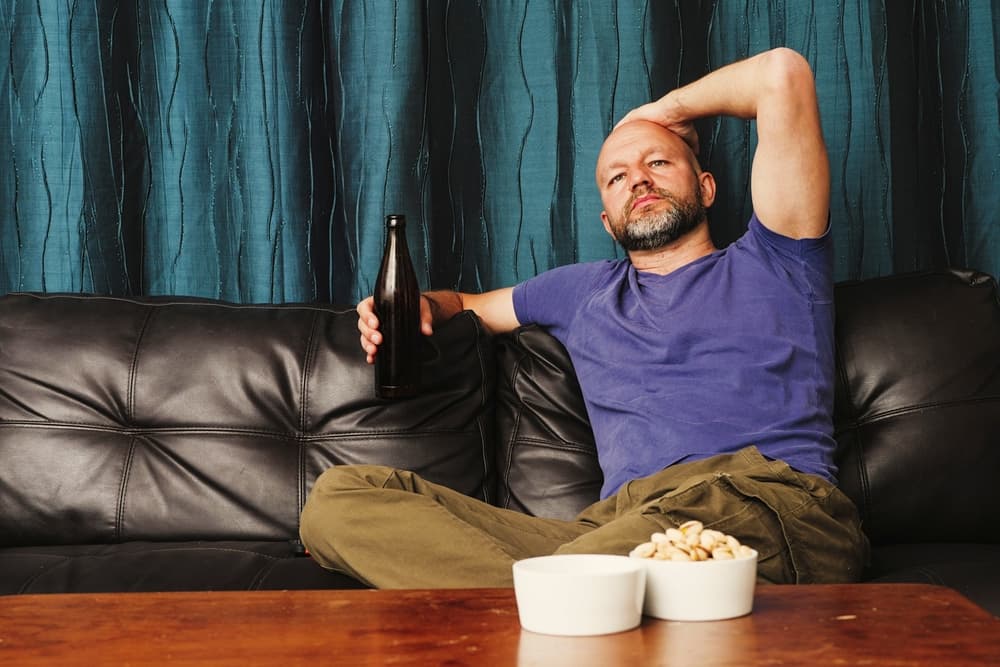 bald man sitting drinking alcohol