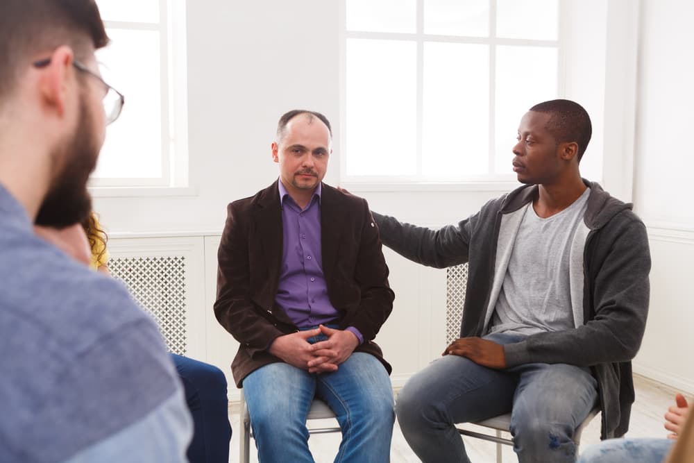 circle of men in inpatient rehab