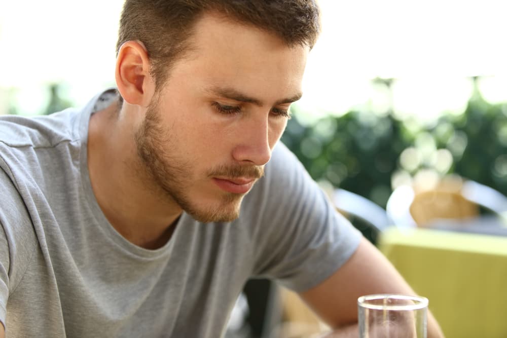 man with low self esteem drinking beer