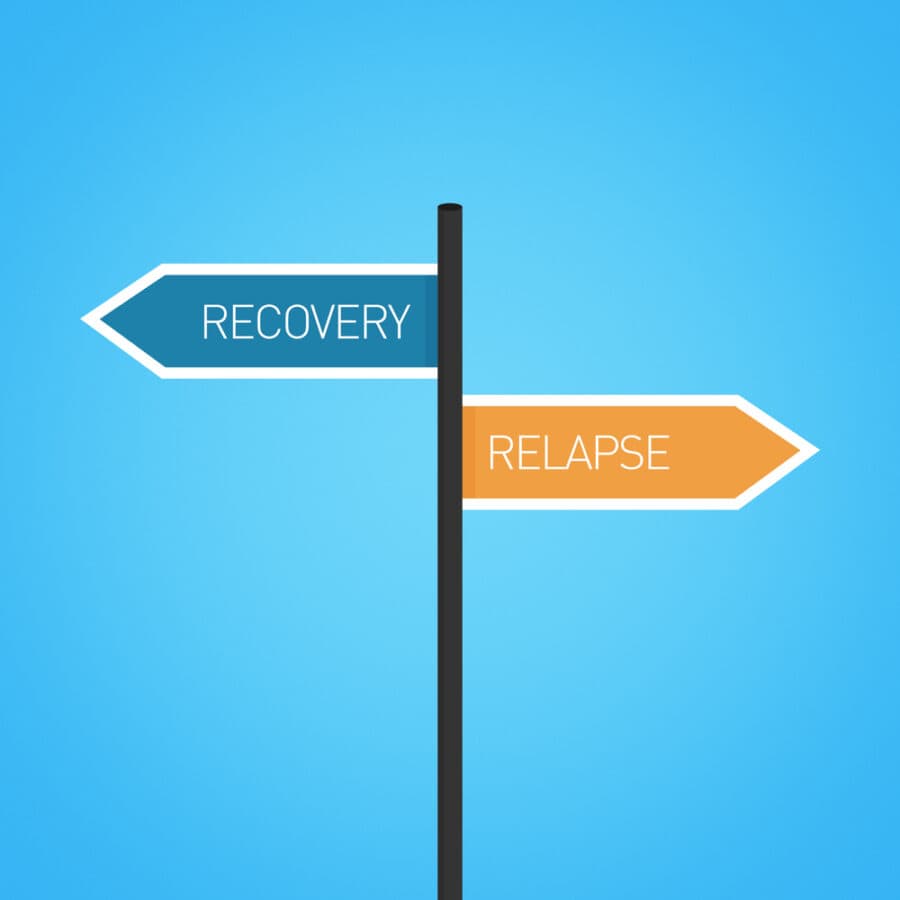 Recovery vs relapse choice road sign concept