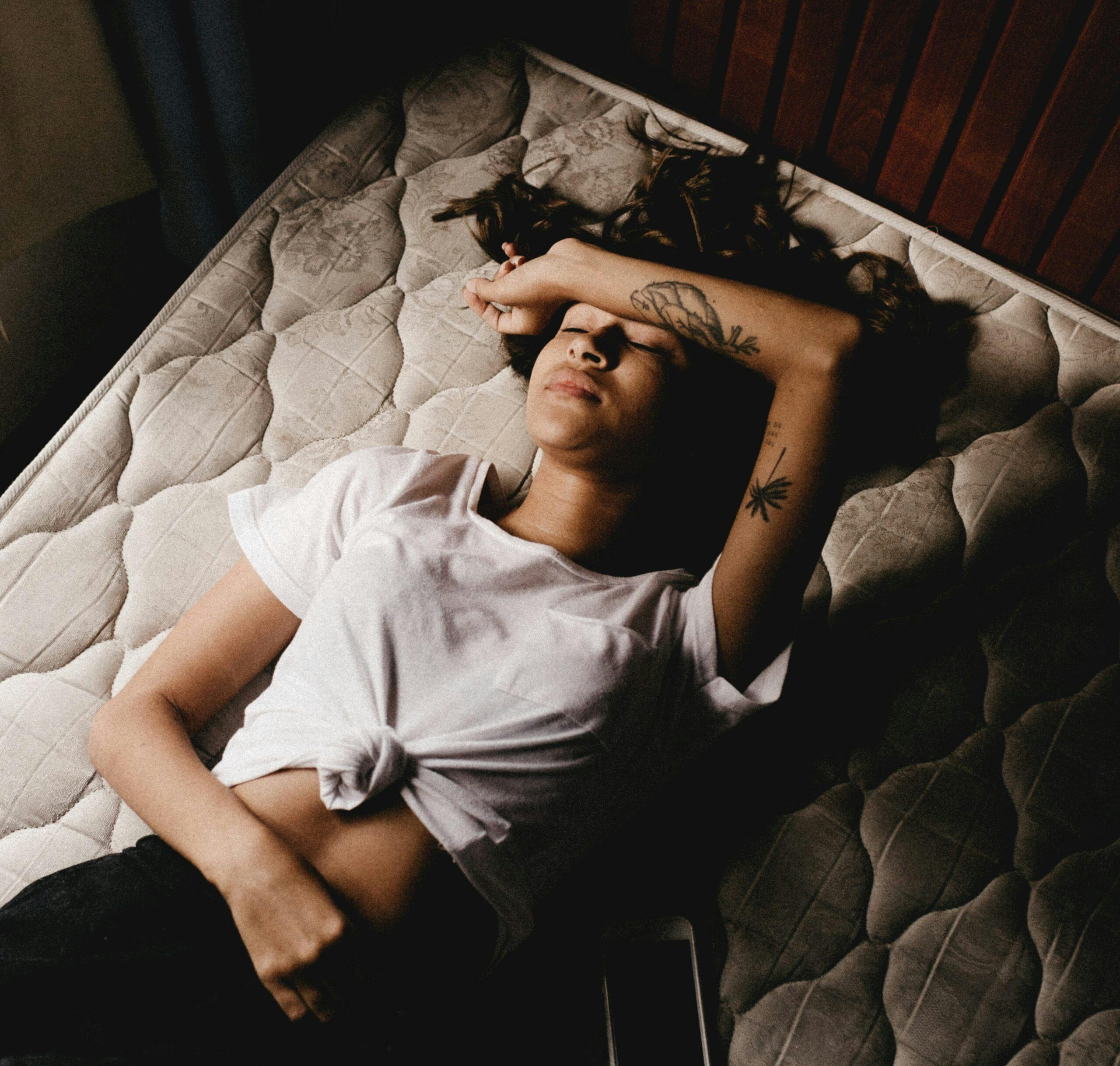 woman lying in mattress