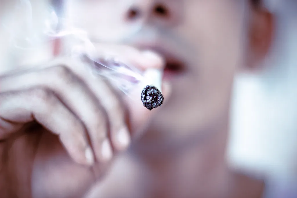 man smoking marijuana joint