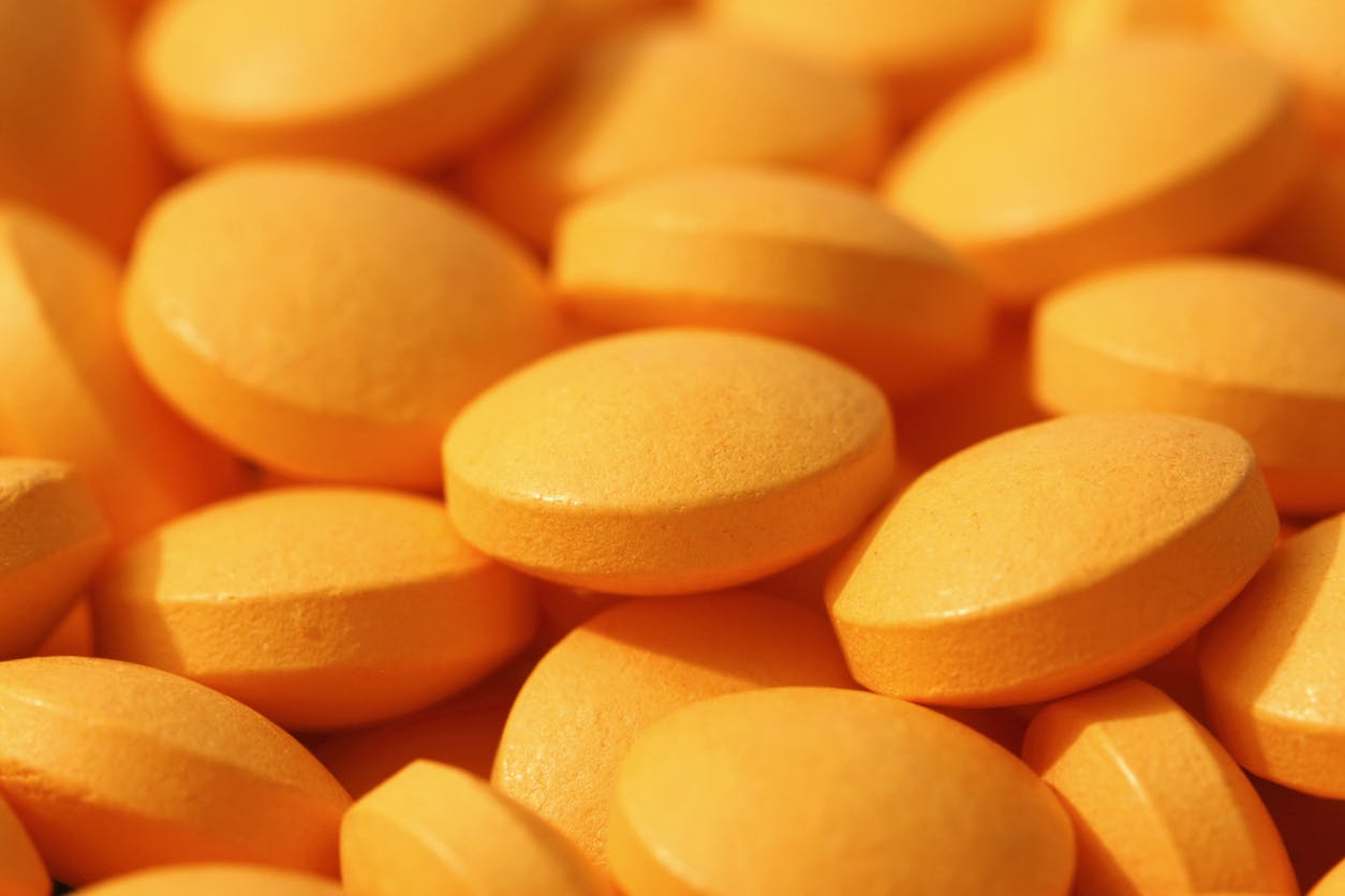 multiple orange pills close up