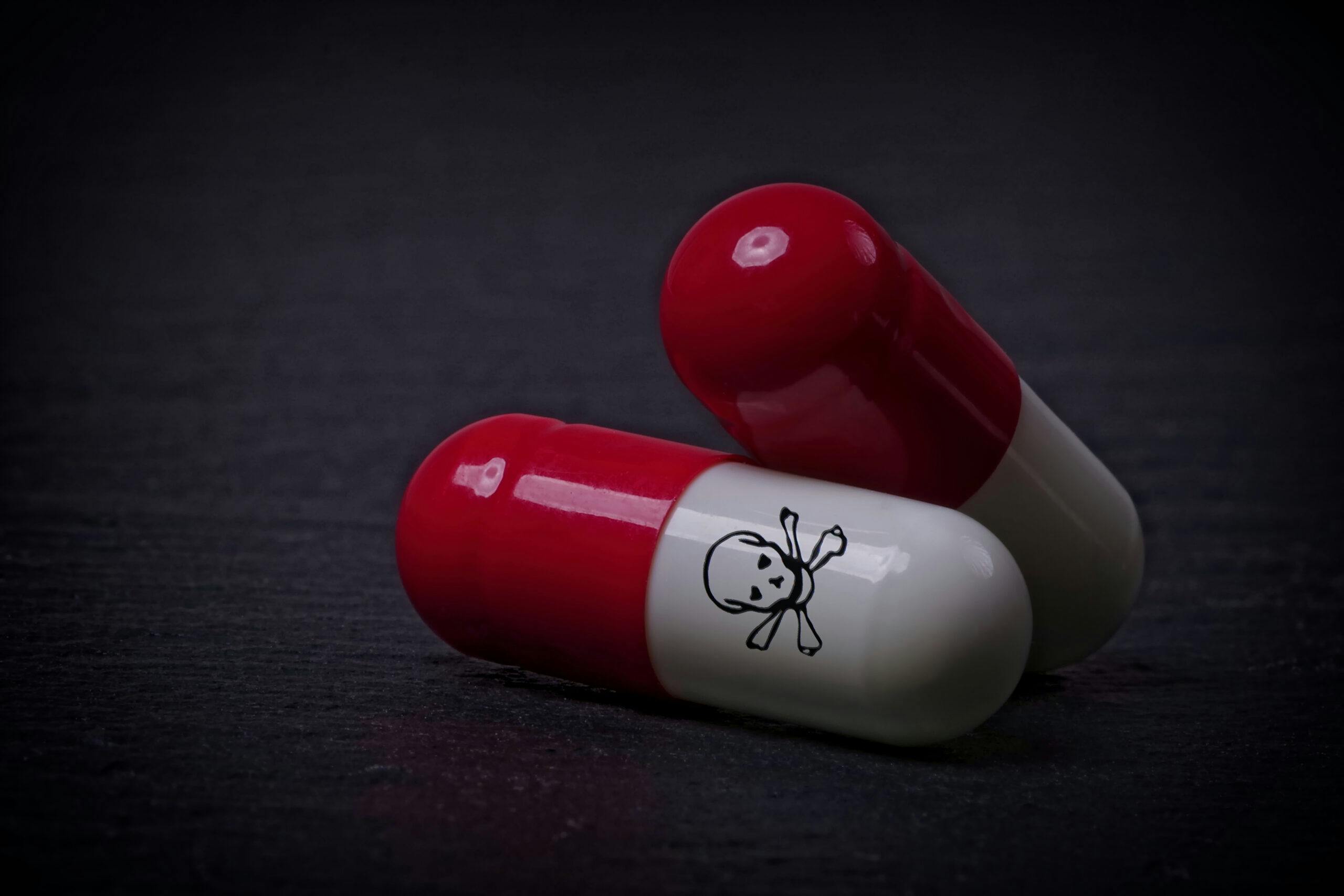 red and white pills with skull and crossbone