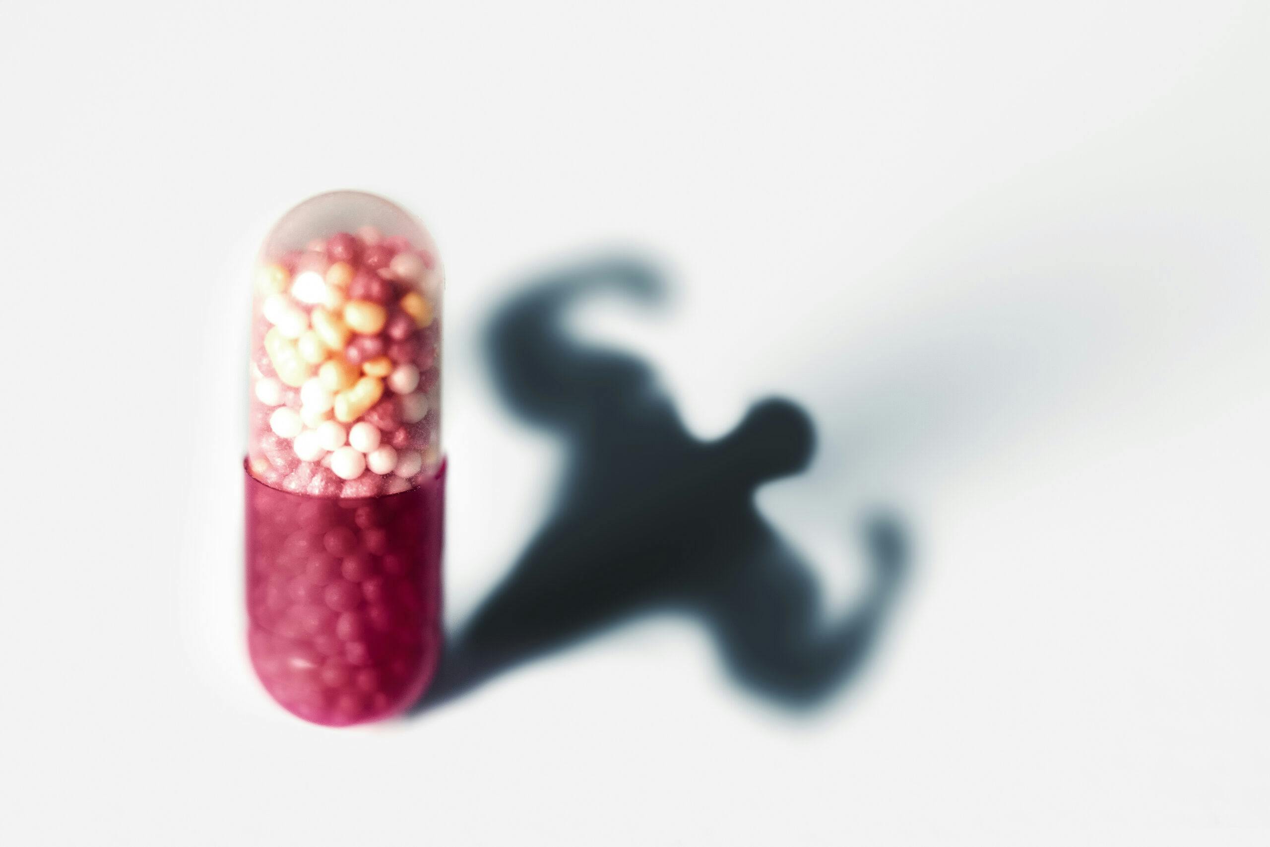 pill capsule muscular man symbol for medical drug abuse