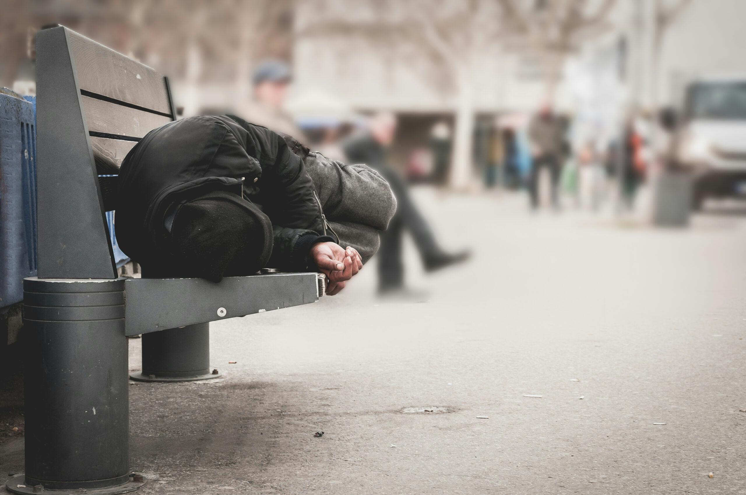 homeless man addict sleeping on bench