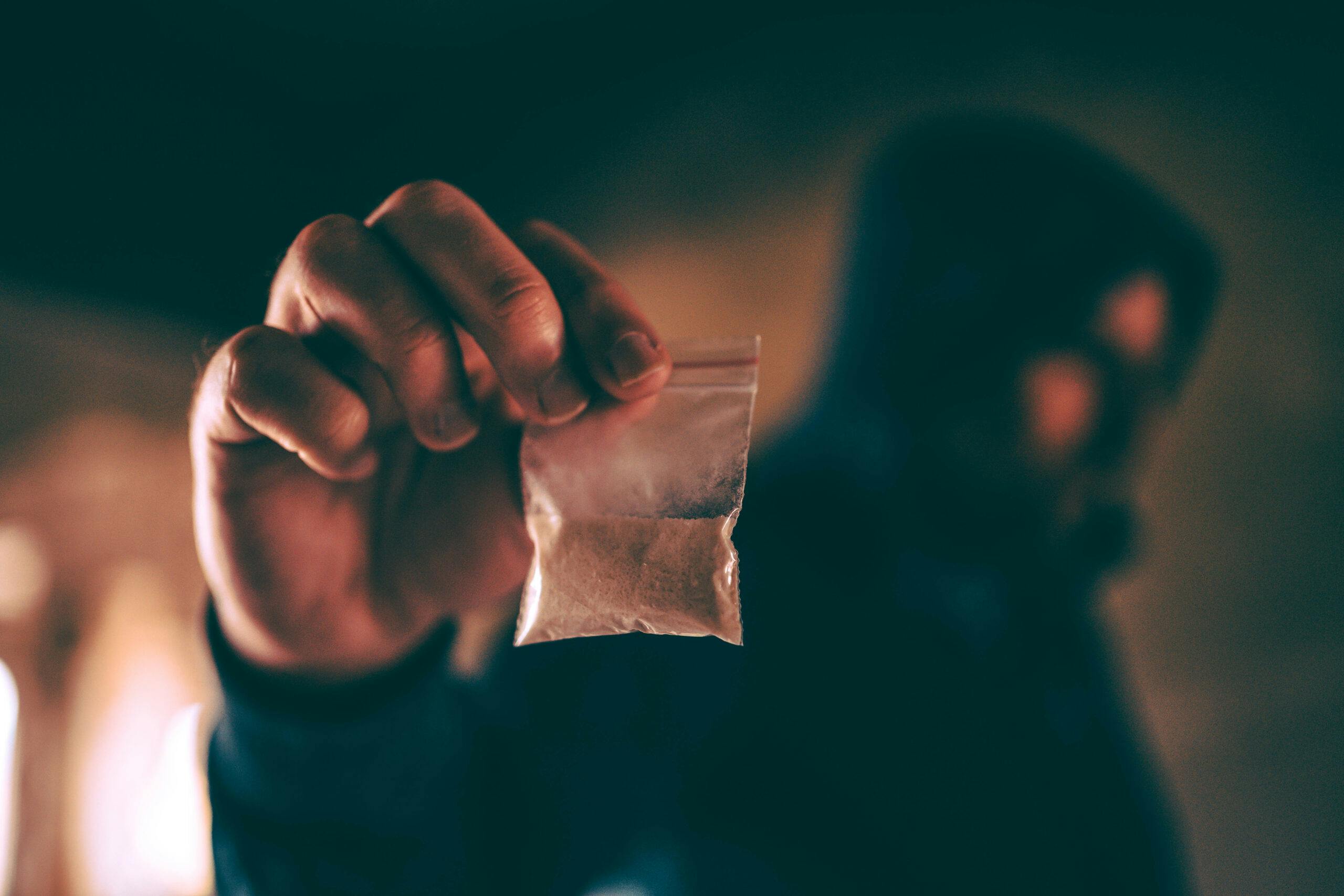 man holding bag of heroin close up
