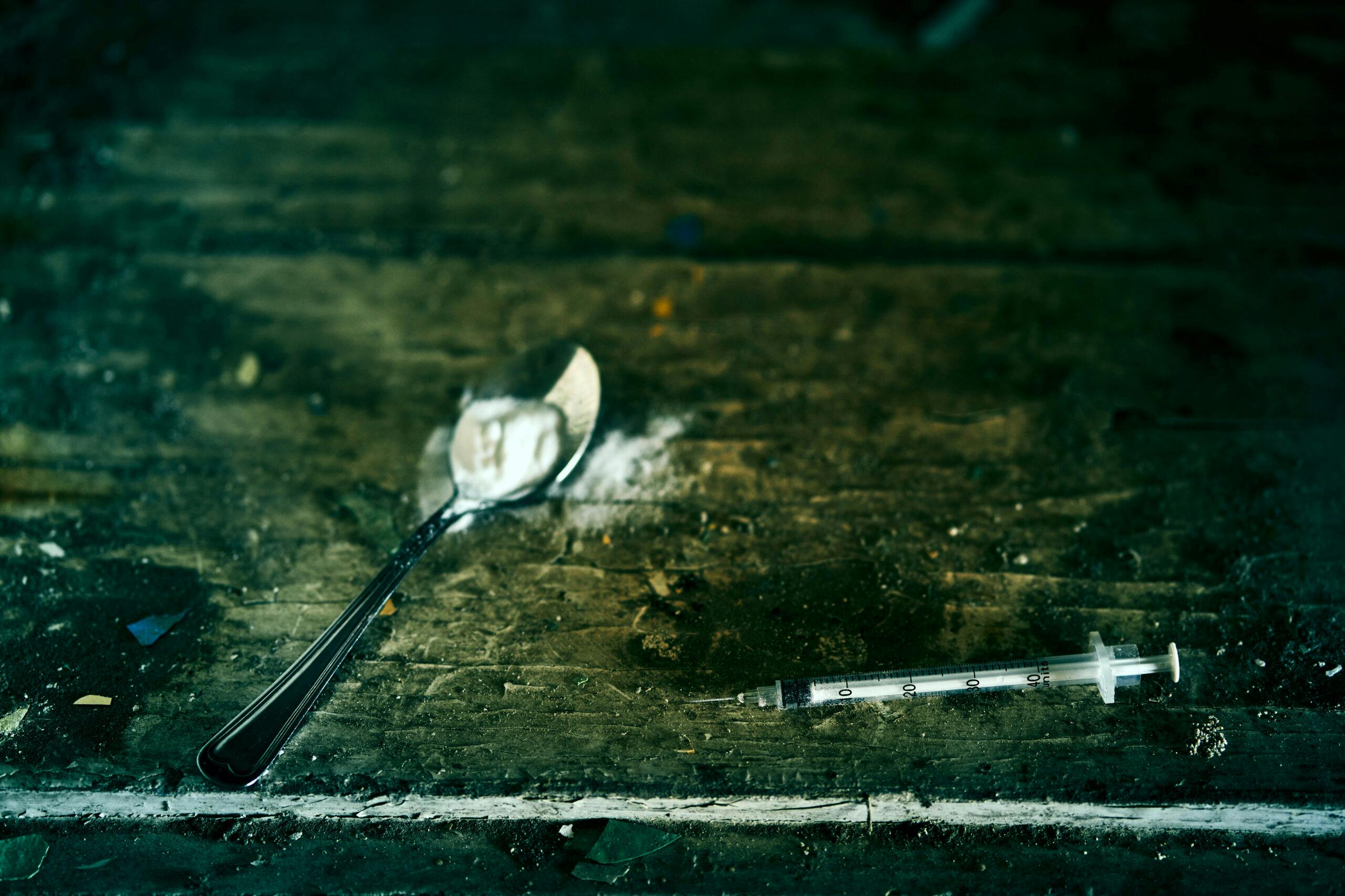 powder drug with spoon and hypodermic needle