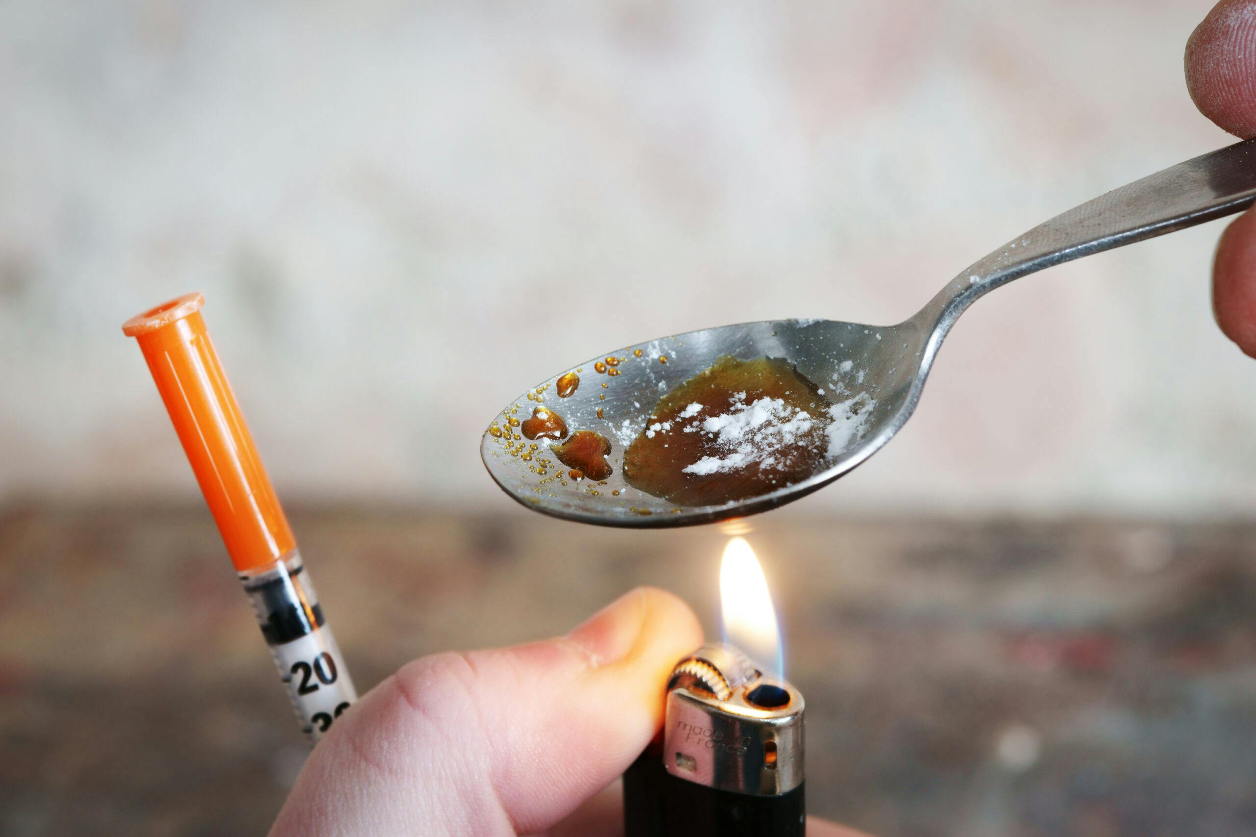 addict cooking heroin and cocaine needle spoon