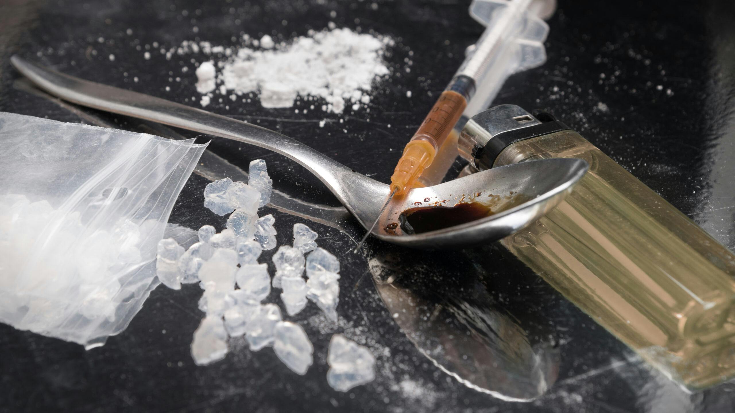 crystal meth and powder with heroin syringe