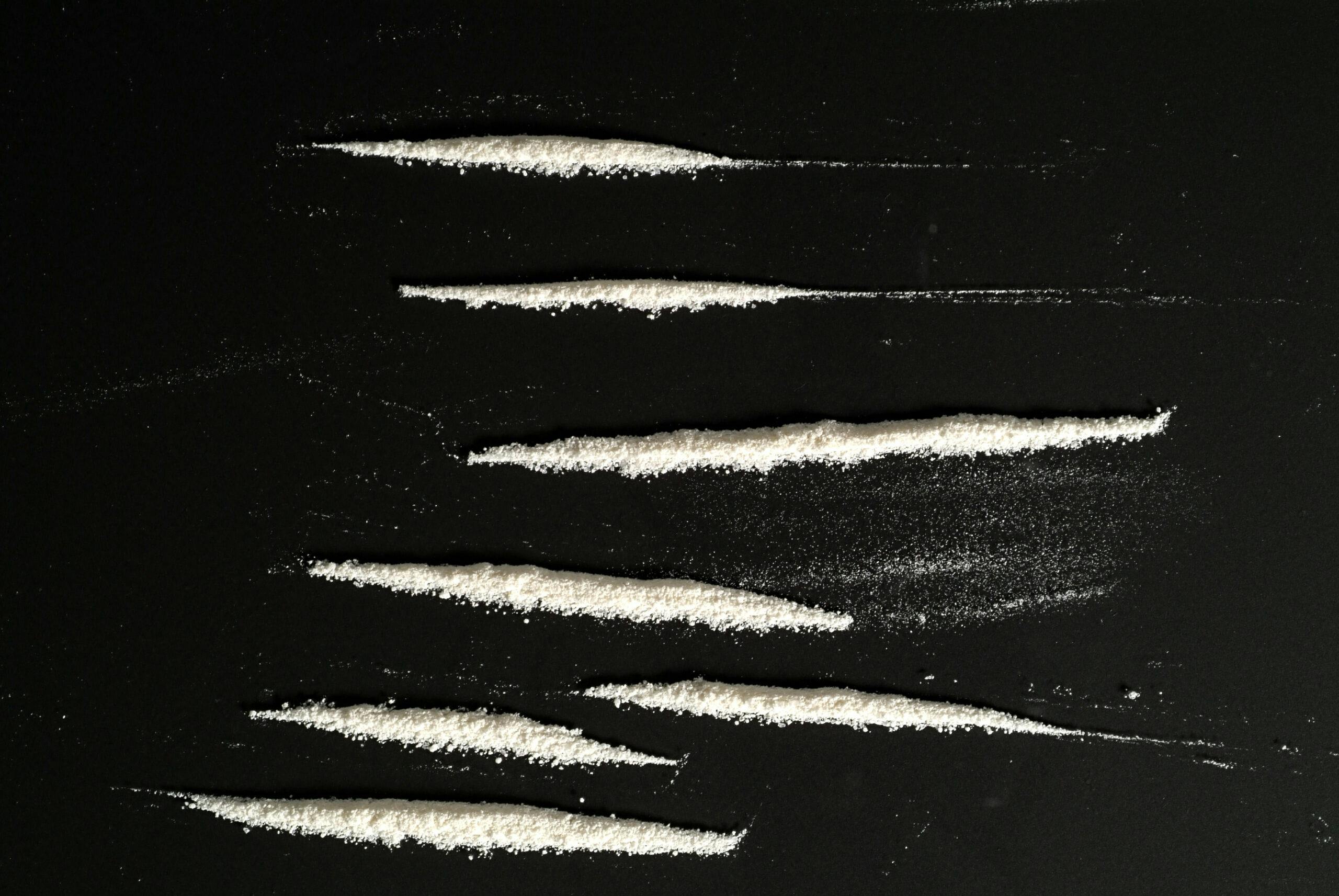 lines of cocaine on black background