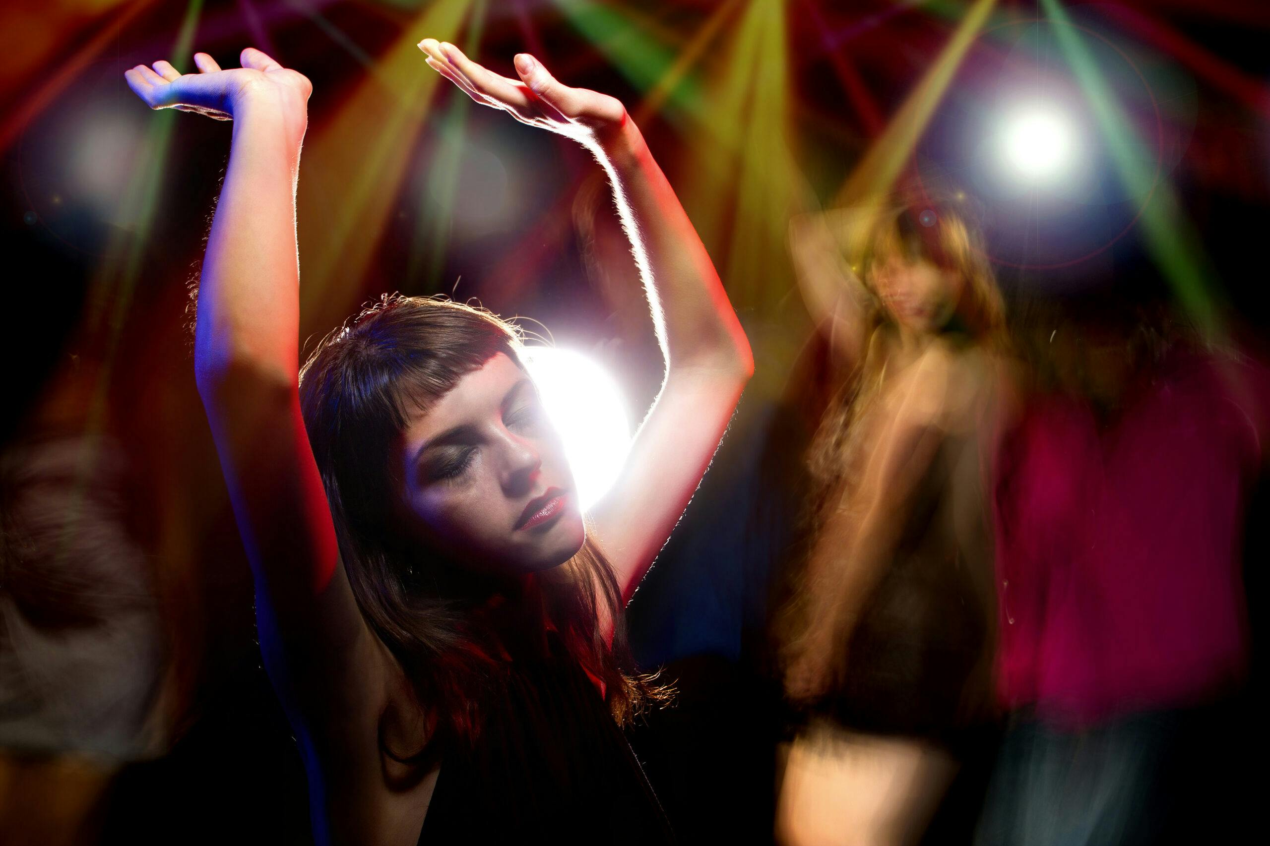 intoxicated woman dancing in lights