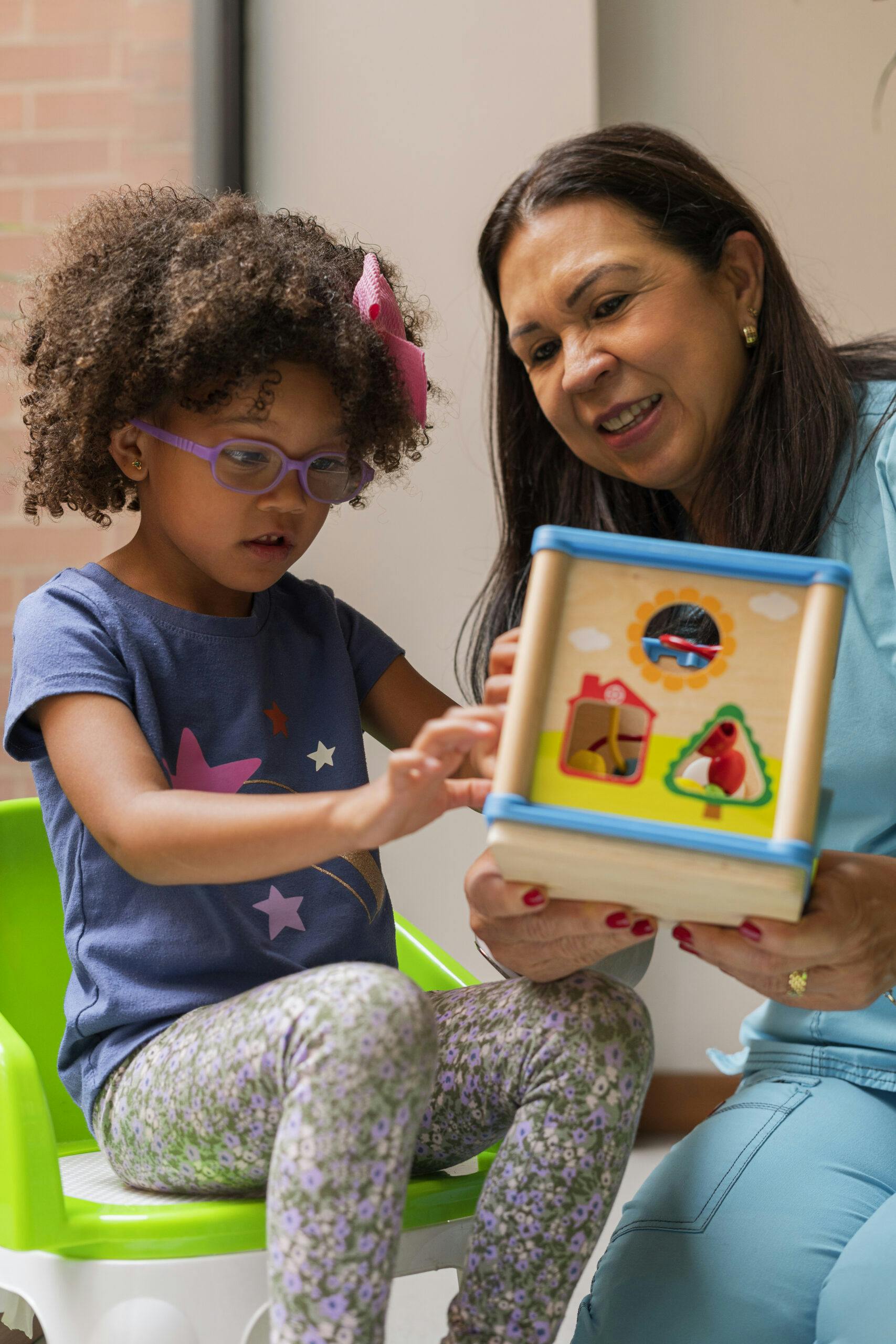 doctor and autistic child with toy