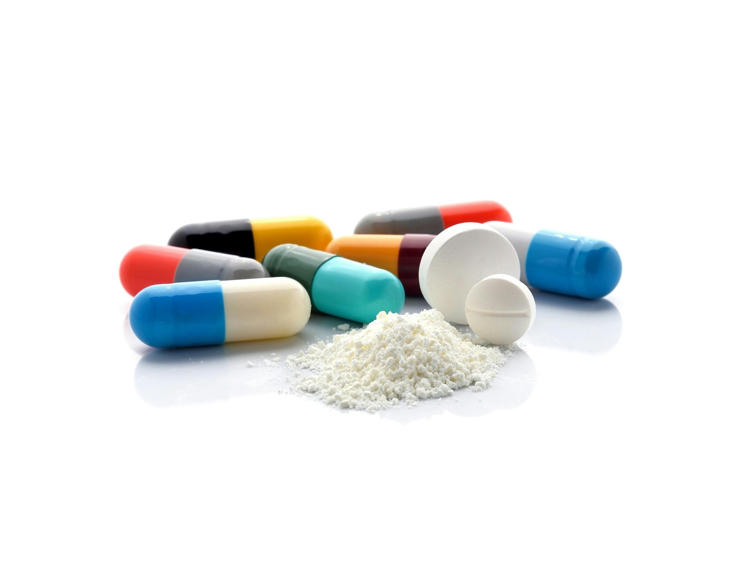 capsule pills and white powder amphetamines