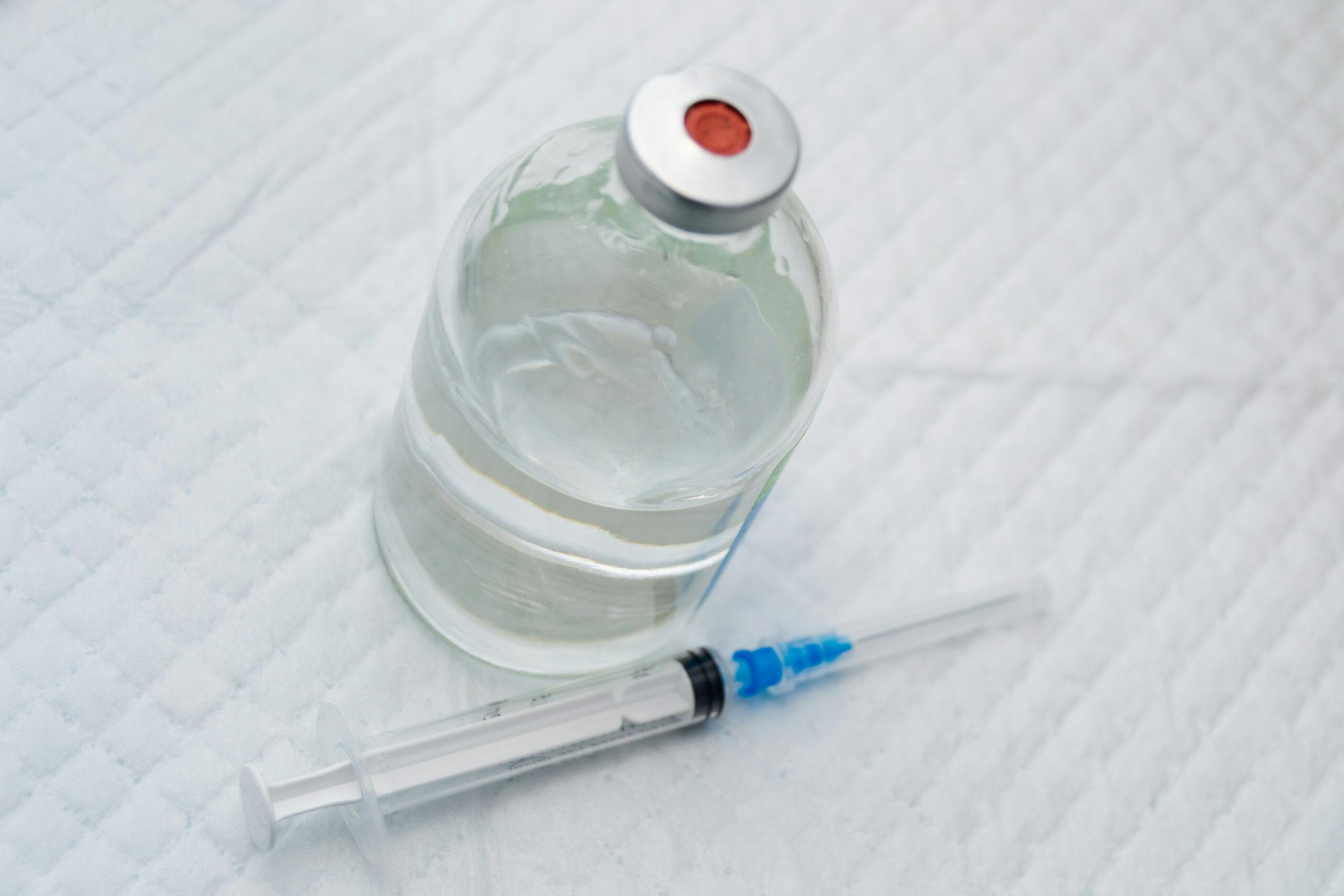 vial with clear ketamine liquid and needle