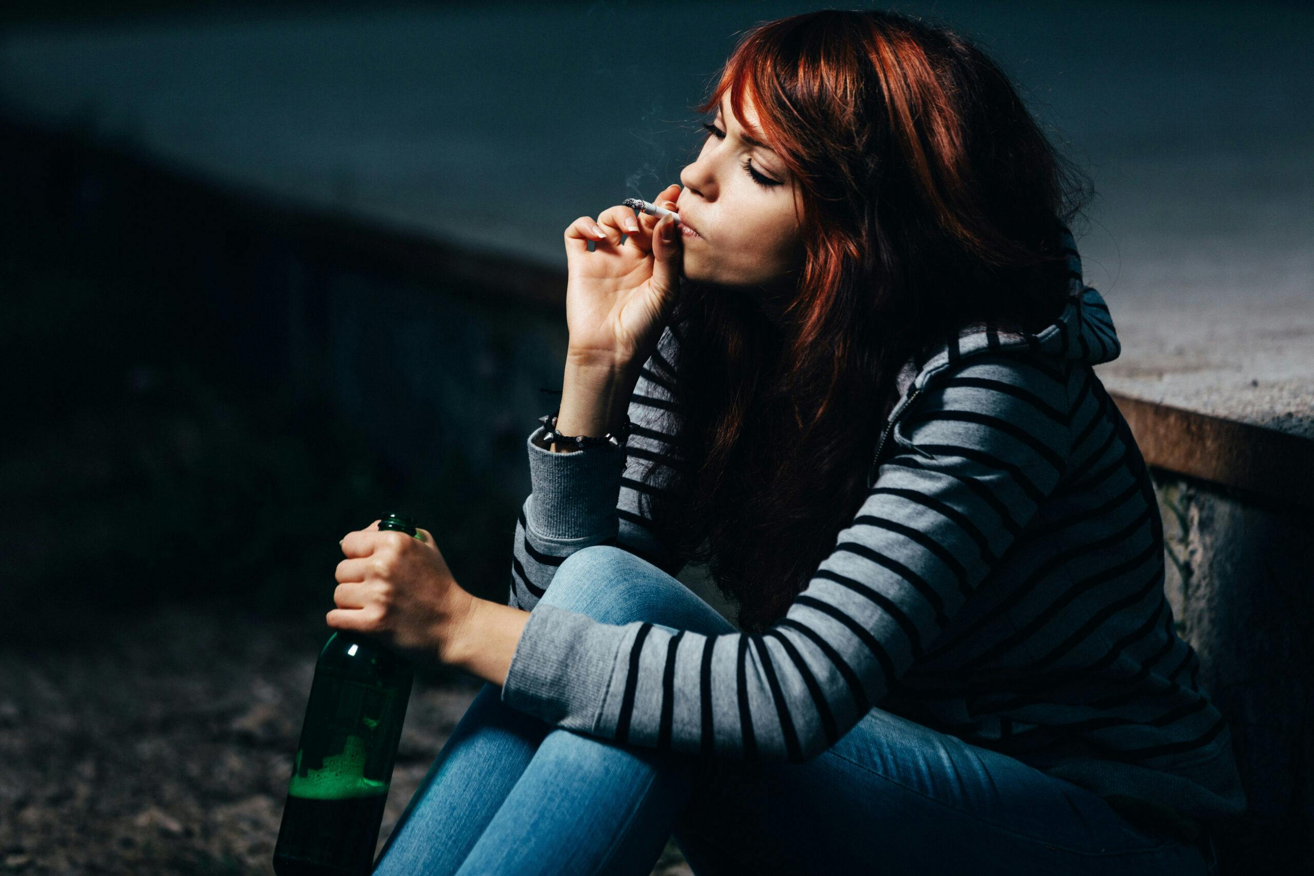 woman smoking marijuana joint and drinking beer