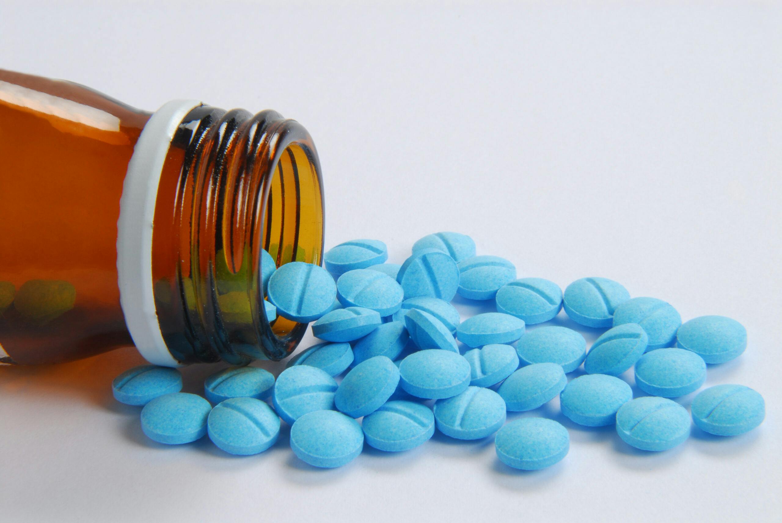 blue klonopin pills spilling from bottle